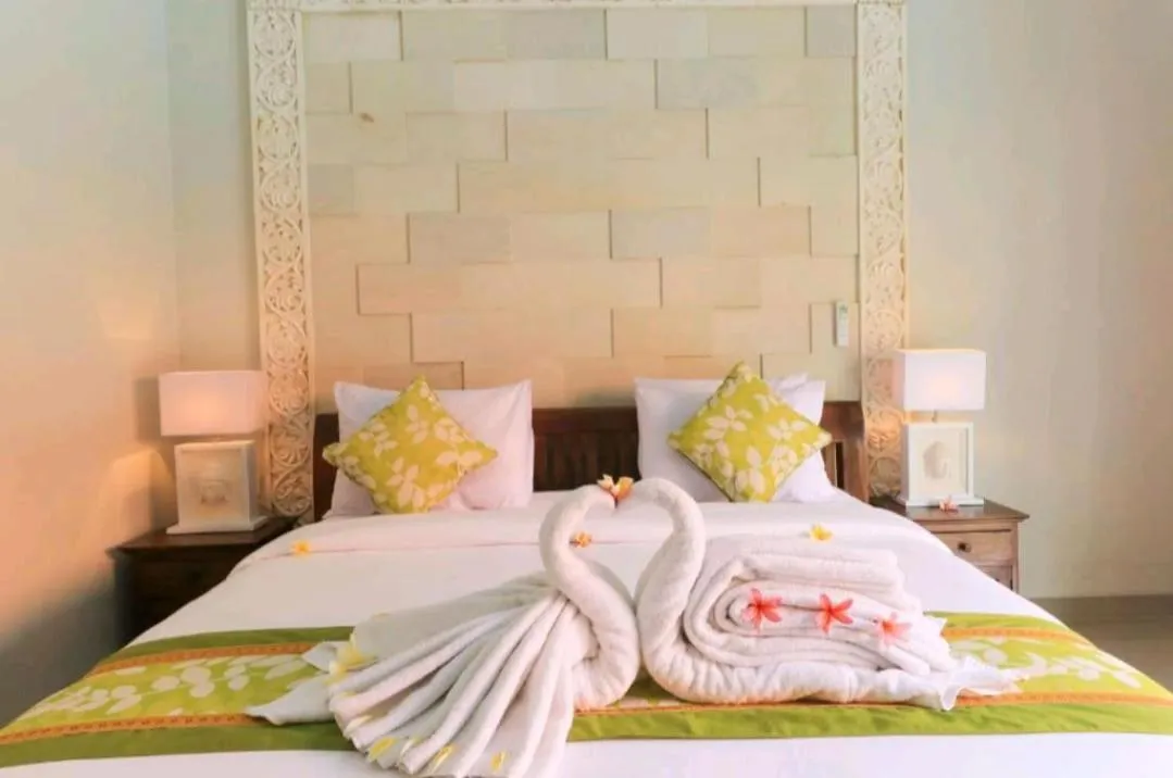 Bed in Three Brothers Bali Legian Bungalows & Villas