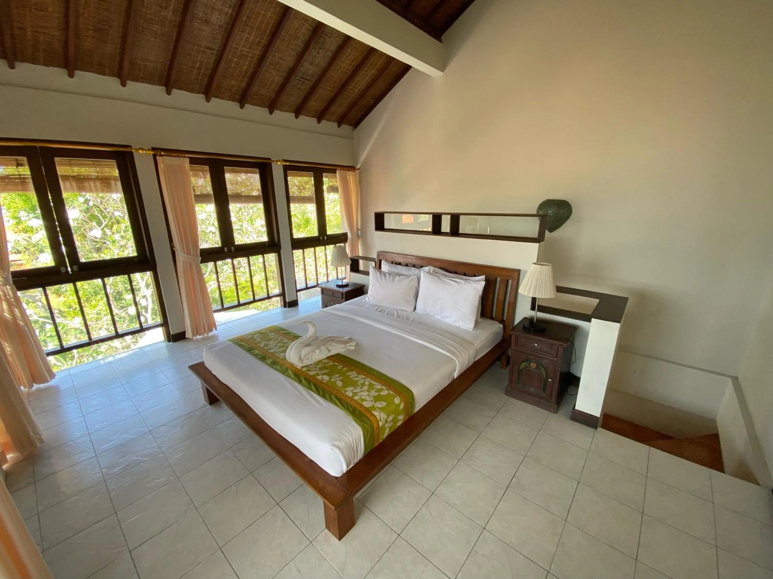 Bed in Three Brothers Bali Legian Bungalows & Villas