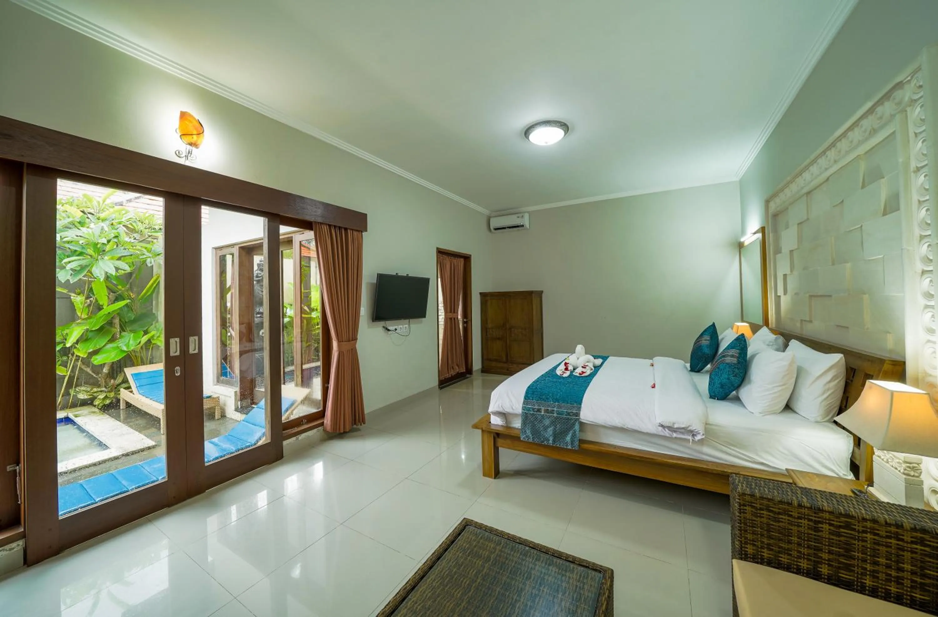 Bed in Three Brothers Bali Legian Bungalows & Villas