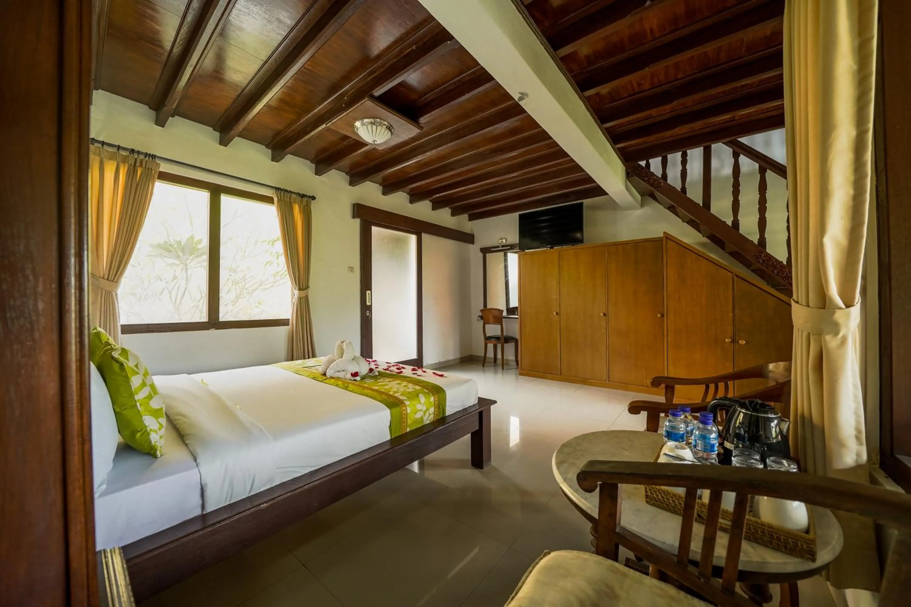 Bed in Three Brothers Bali Legian Bungalows & Villas