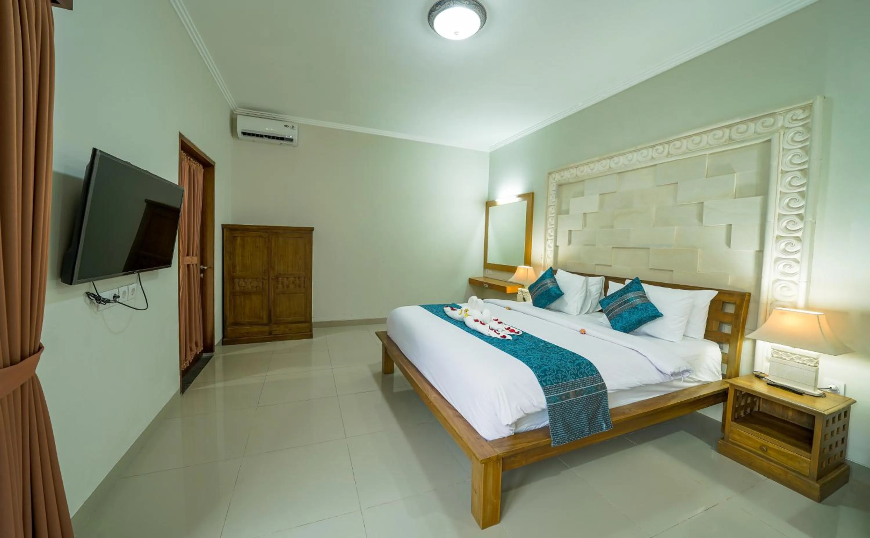 Bed in Three Brothers Bali Legian Bungalows & Villas