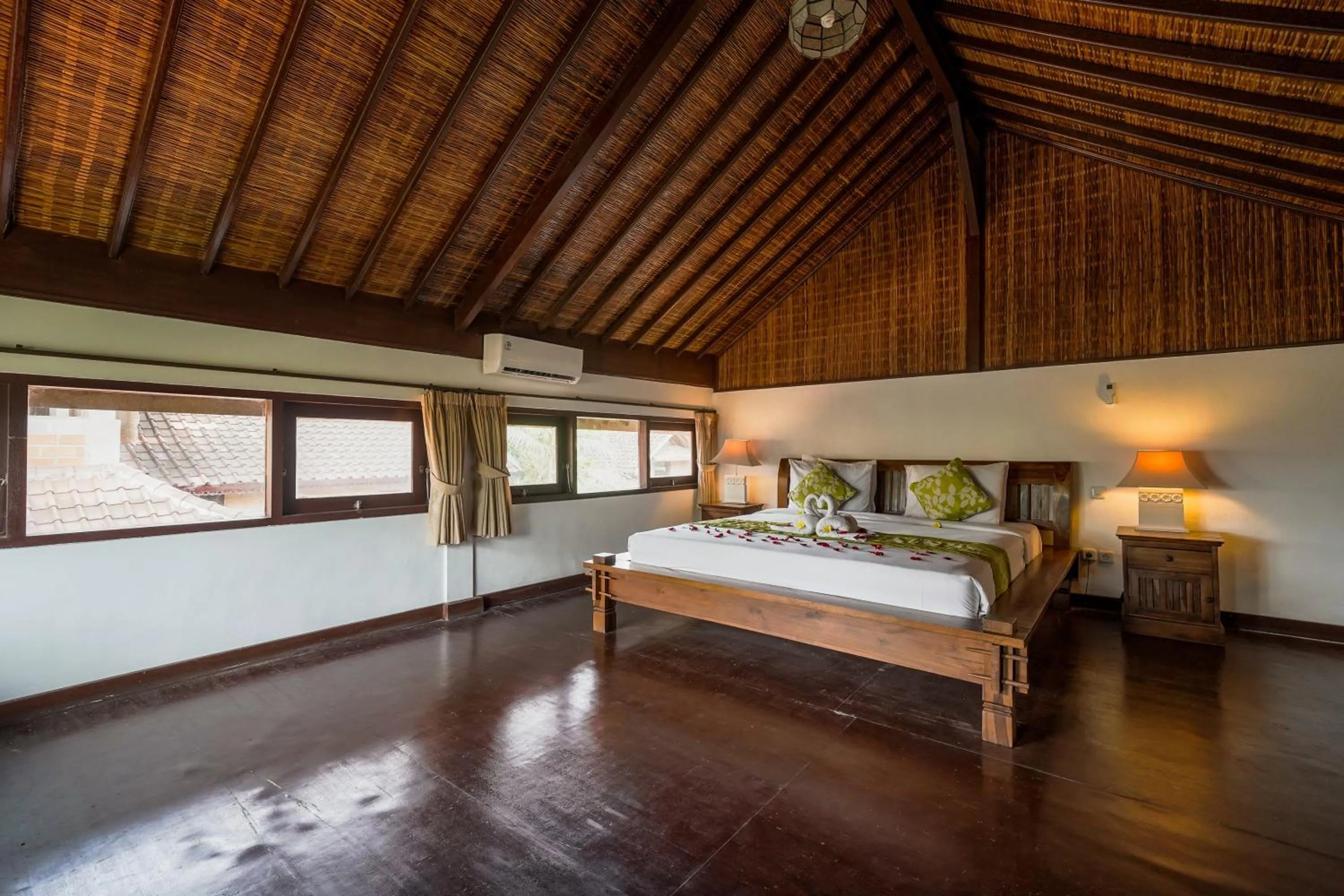 Bed in Three Brothers Bali Legian Bungalows & Villas
