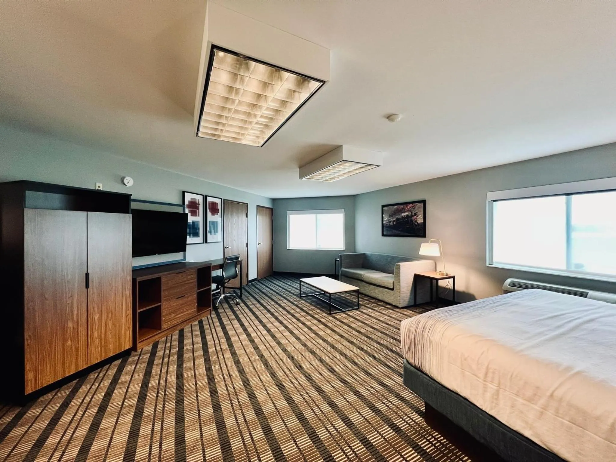 Bed in AmericInn by Wyndham Beaver Dam