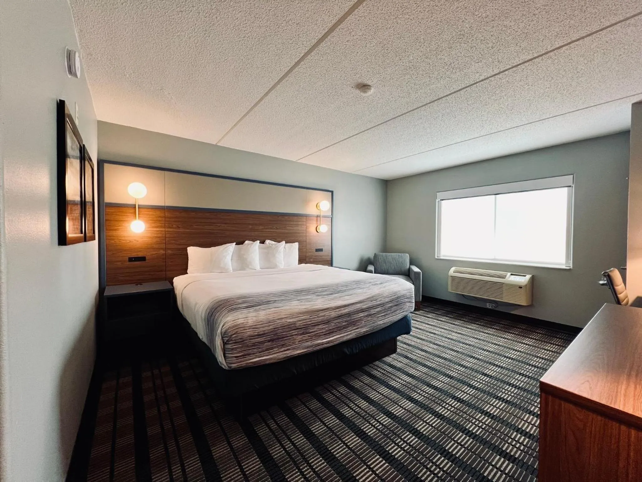 Bed in AmericInn by Wyndham Beaver Dam