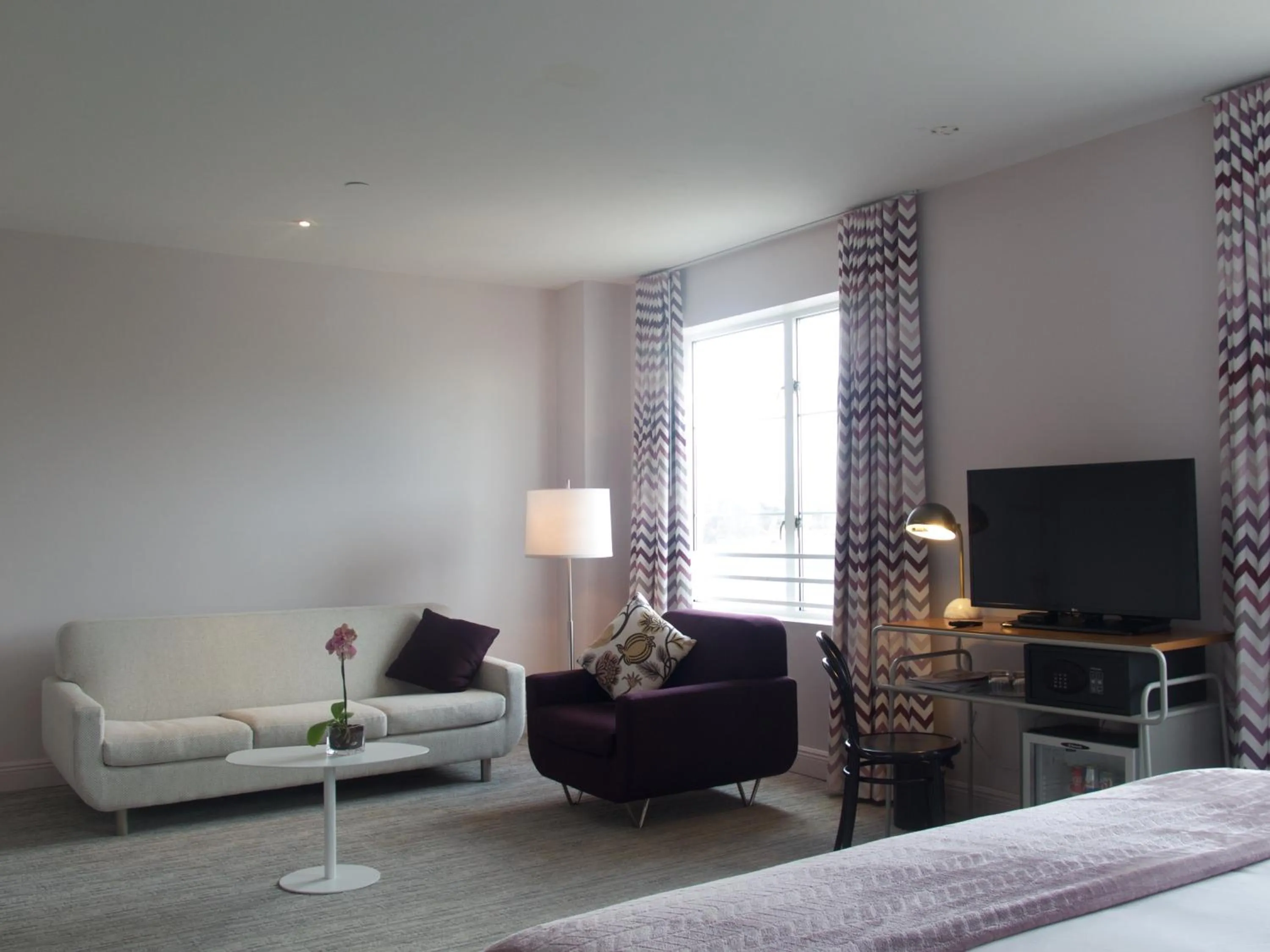 Bedroom, Seating Area in The Astor by LuxUrban