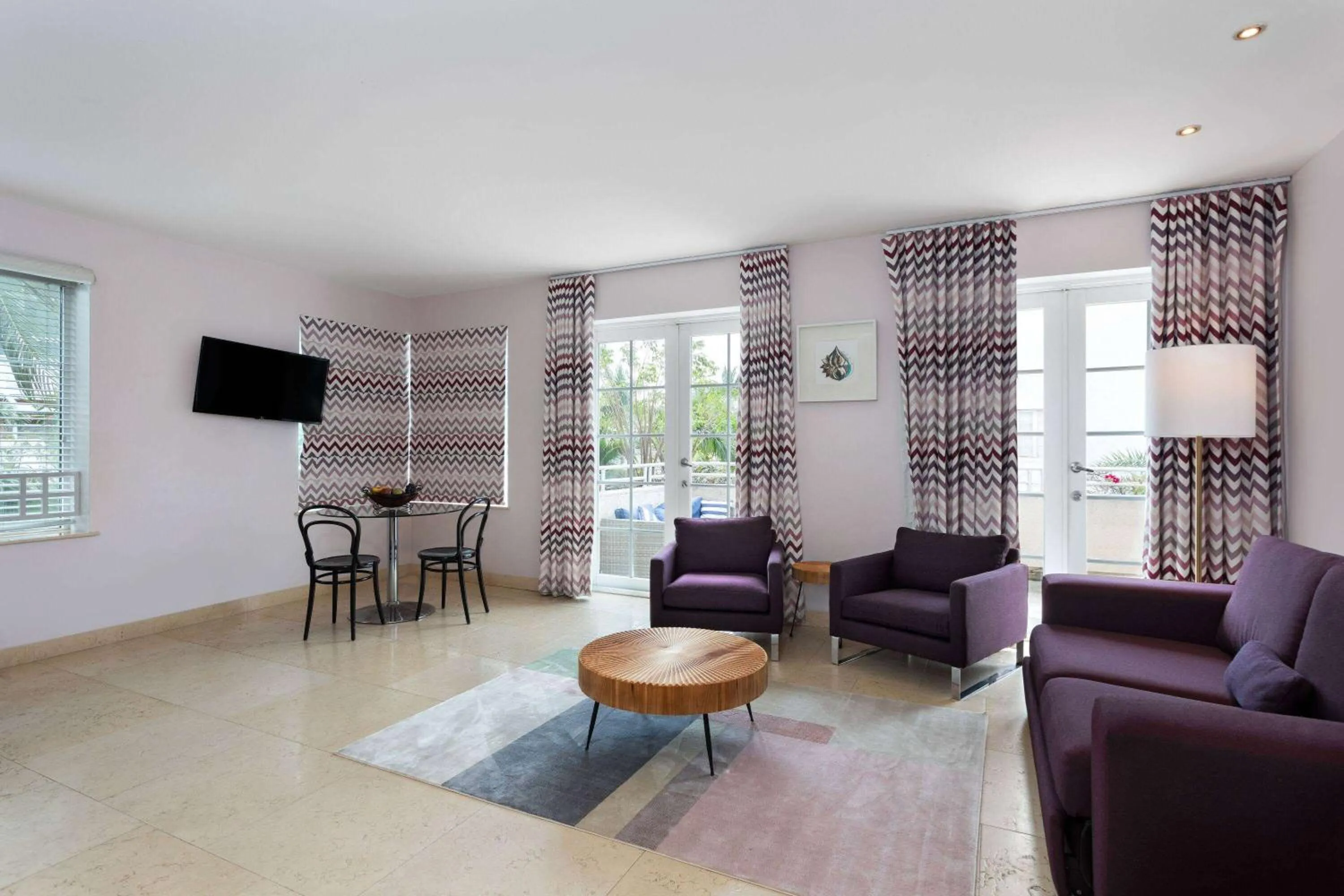 Bed, Seating Area in The Astor by LuxUrban