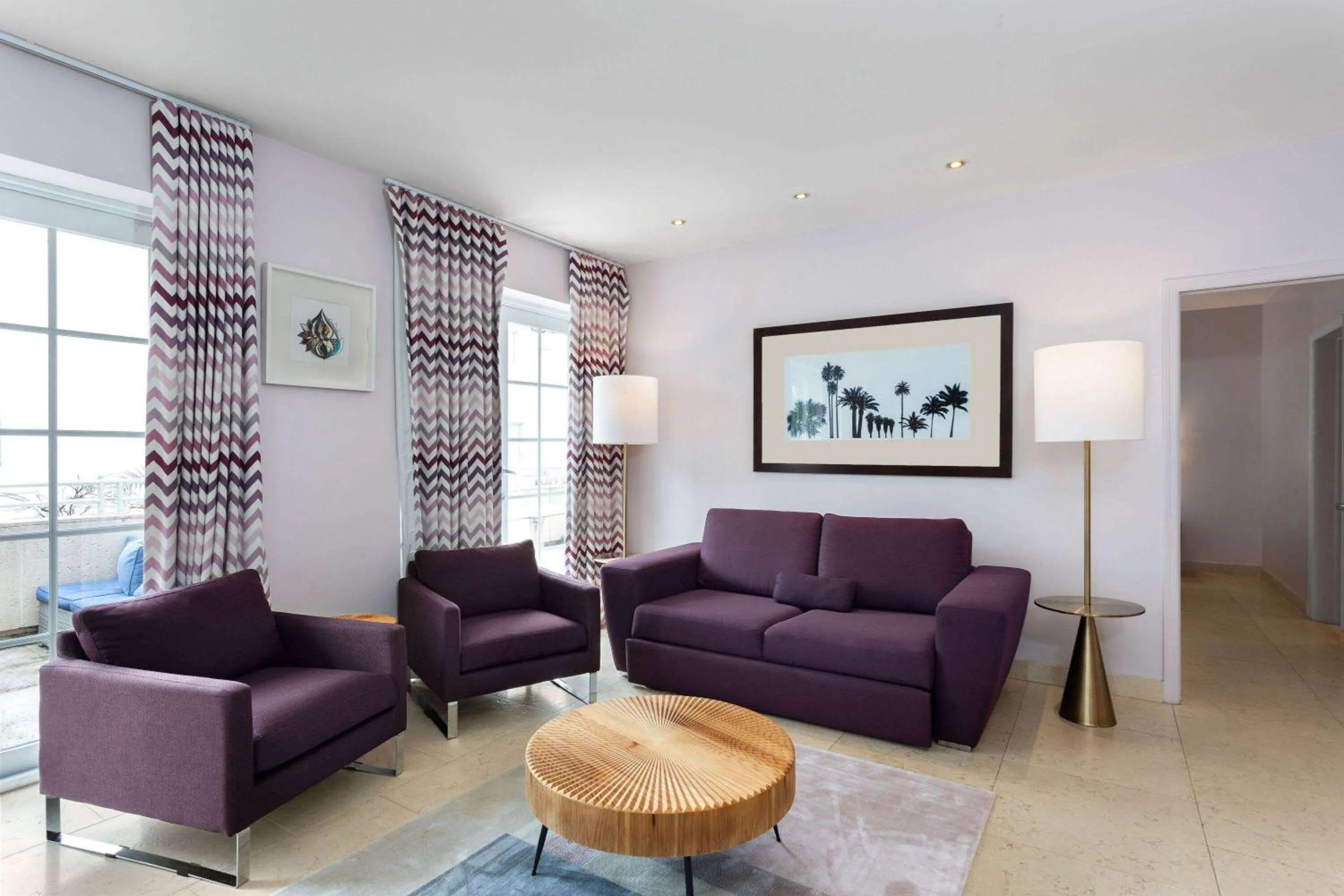 Bed, Seating Area in The Astor by LuxUrban