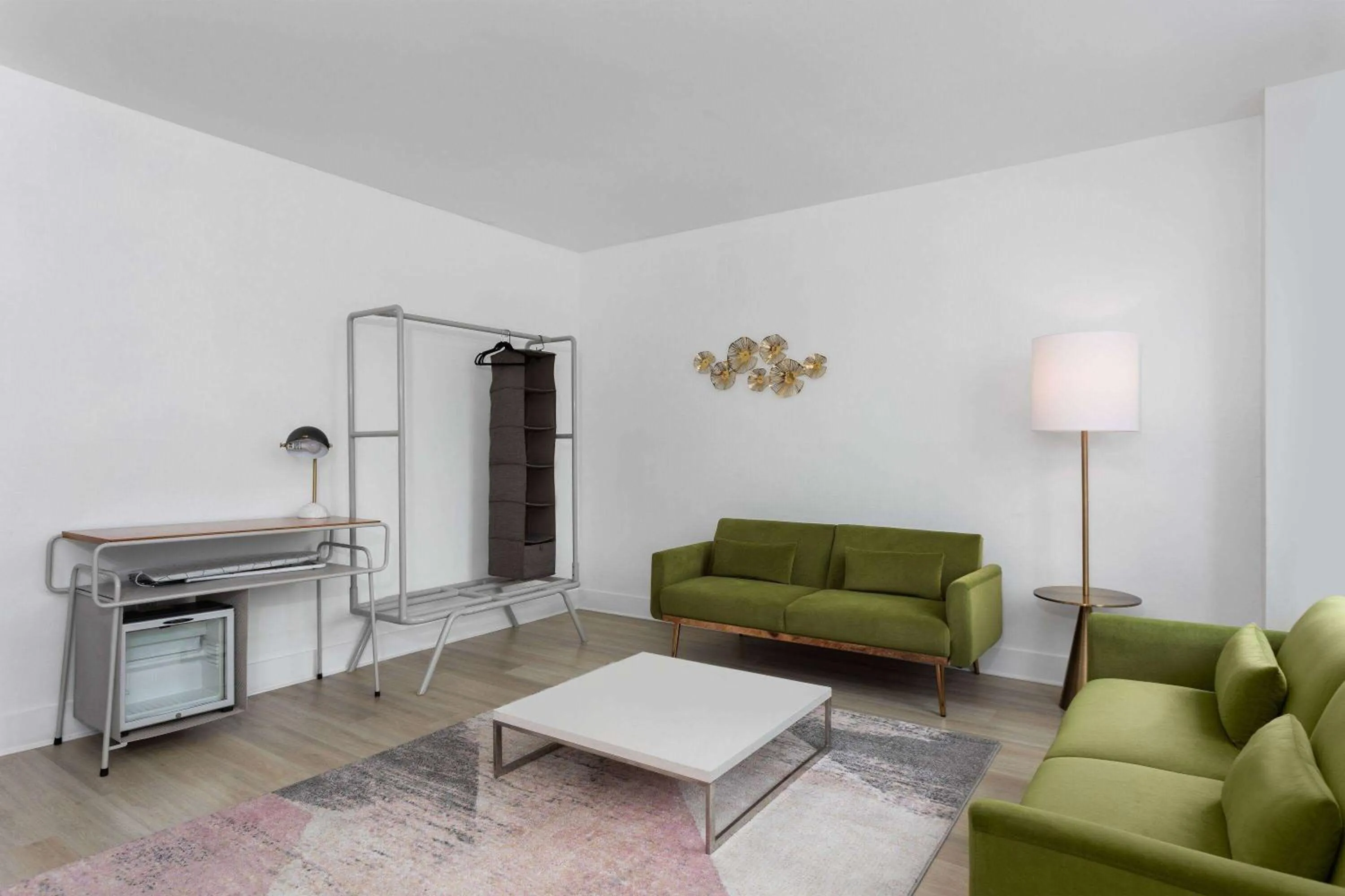 Bed, Seating Area in The Astor by LuxUrban