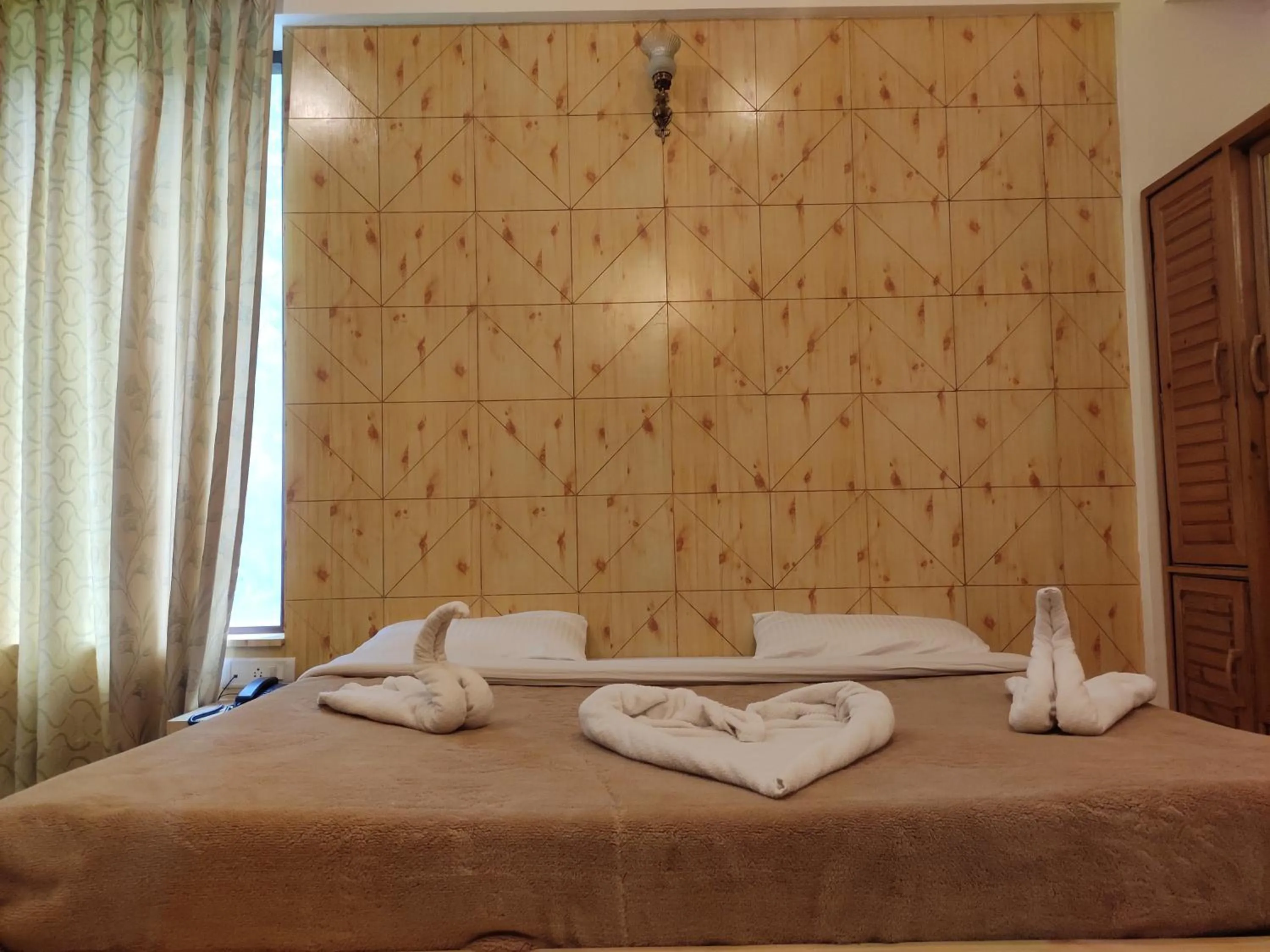 Bedroom in Greenwoods Inn Mcleodganj #Parking #lift #All Balcony Rooms #Rooftop Terrace #Prime Location # Close to the Triund Trek Point 400 Mtr Head