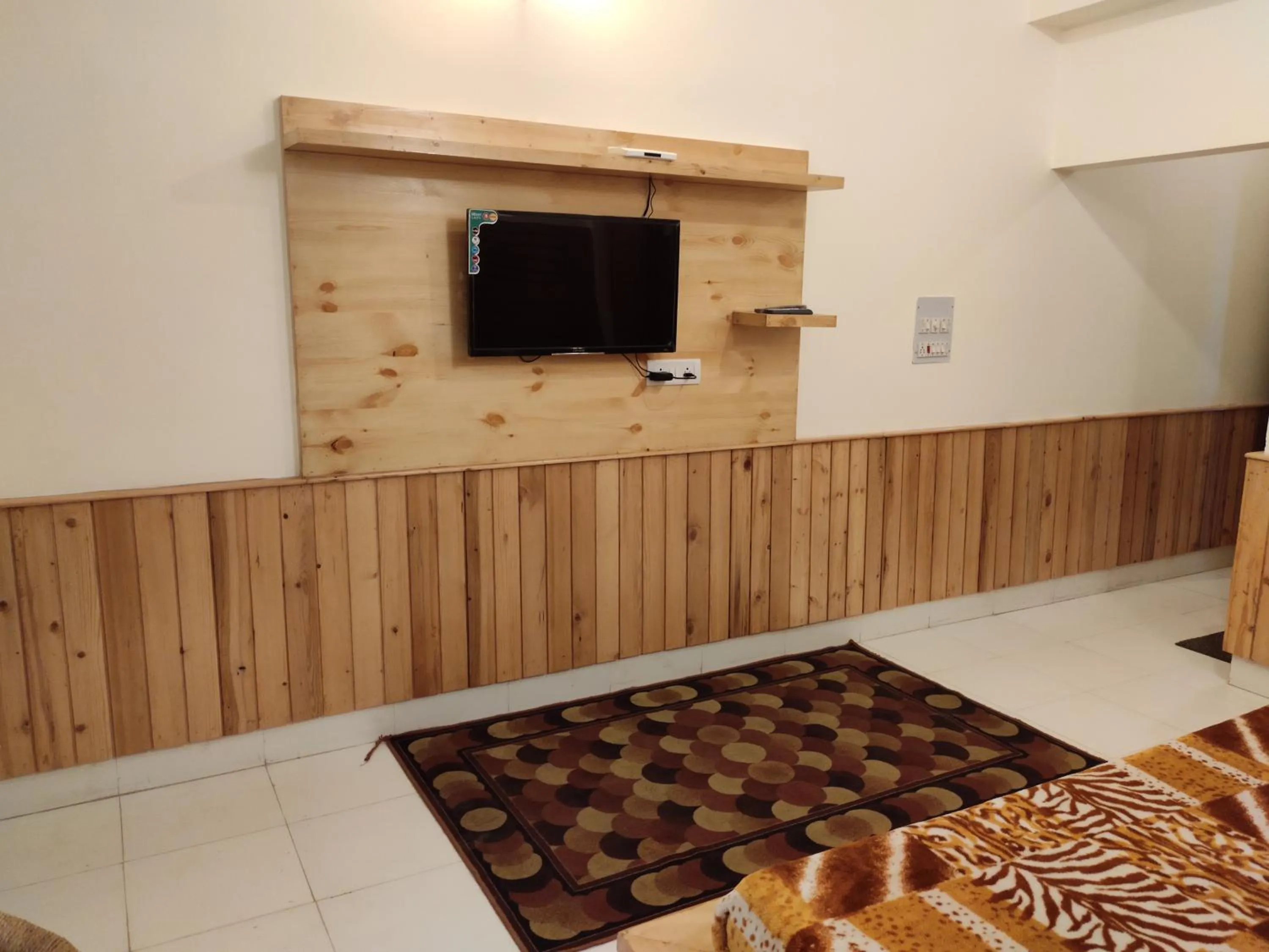 TV and multimedia in Greenwoods Inn Mcleodganj #Parking #lift #All Balcony Rooms #Rooftop Terrace #Prime Location # Close to the Triund Trek Point 400 Mtr Head