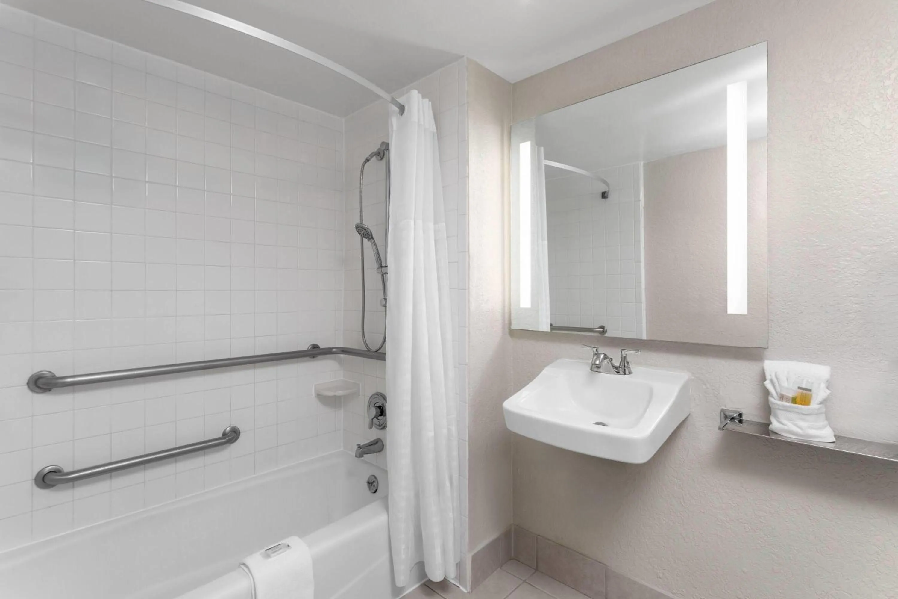 Bathroom in Days Inn by Wyndham Orlando Conv. Center/International Dr