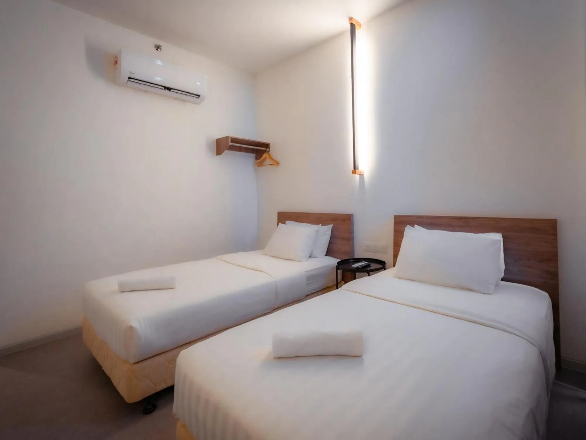 Bed in T+ PREMIUM HOTEL