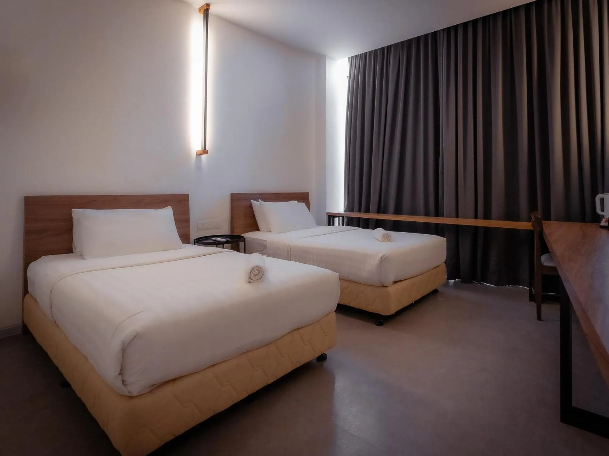 Bed in T+ PREMIUM HOTEL