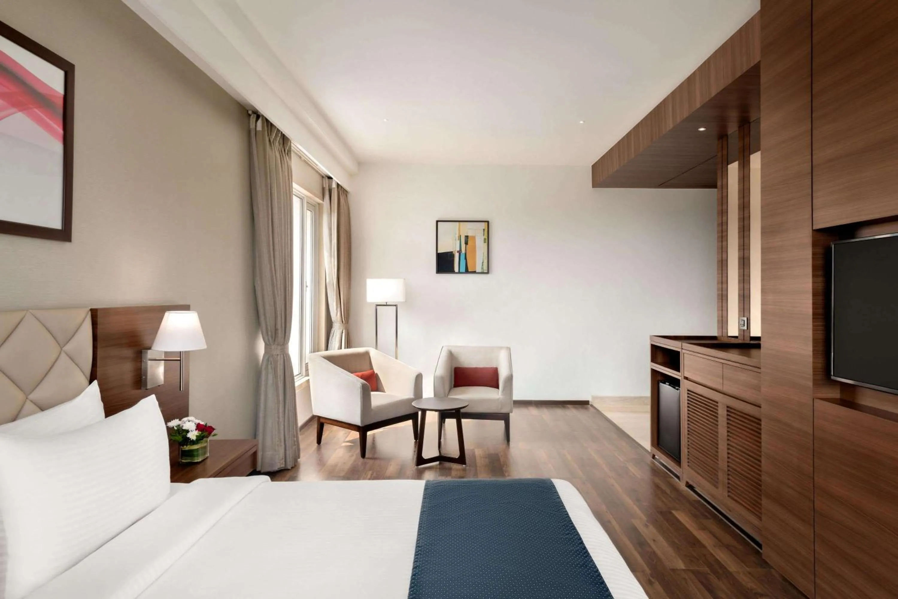 Photo of the whole room, Bed in Ramada by Wyndham Gandhidham Shinay