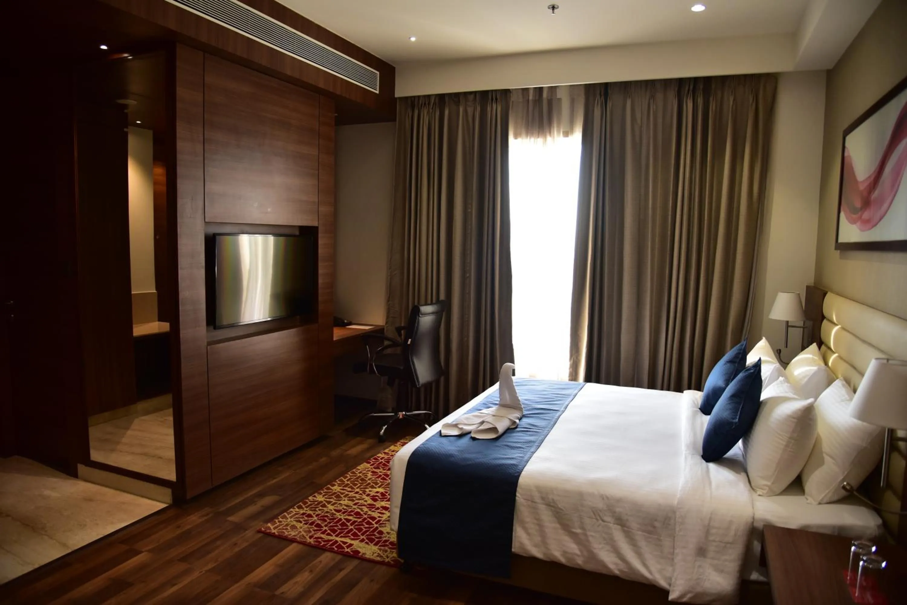 Bathroom, Bed in Ramada by Wyndham Gandhidham Shinay