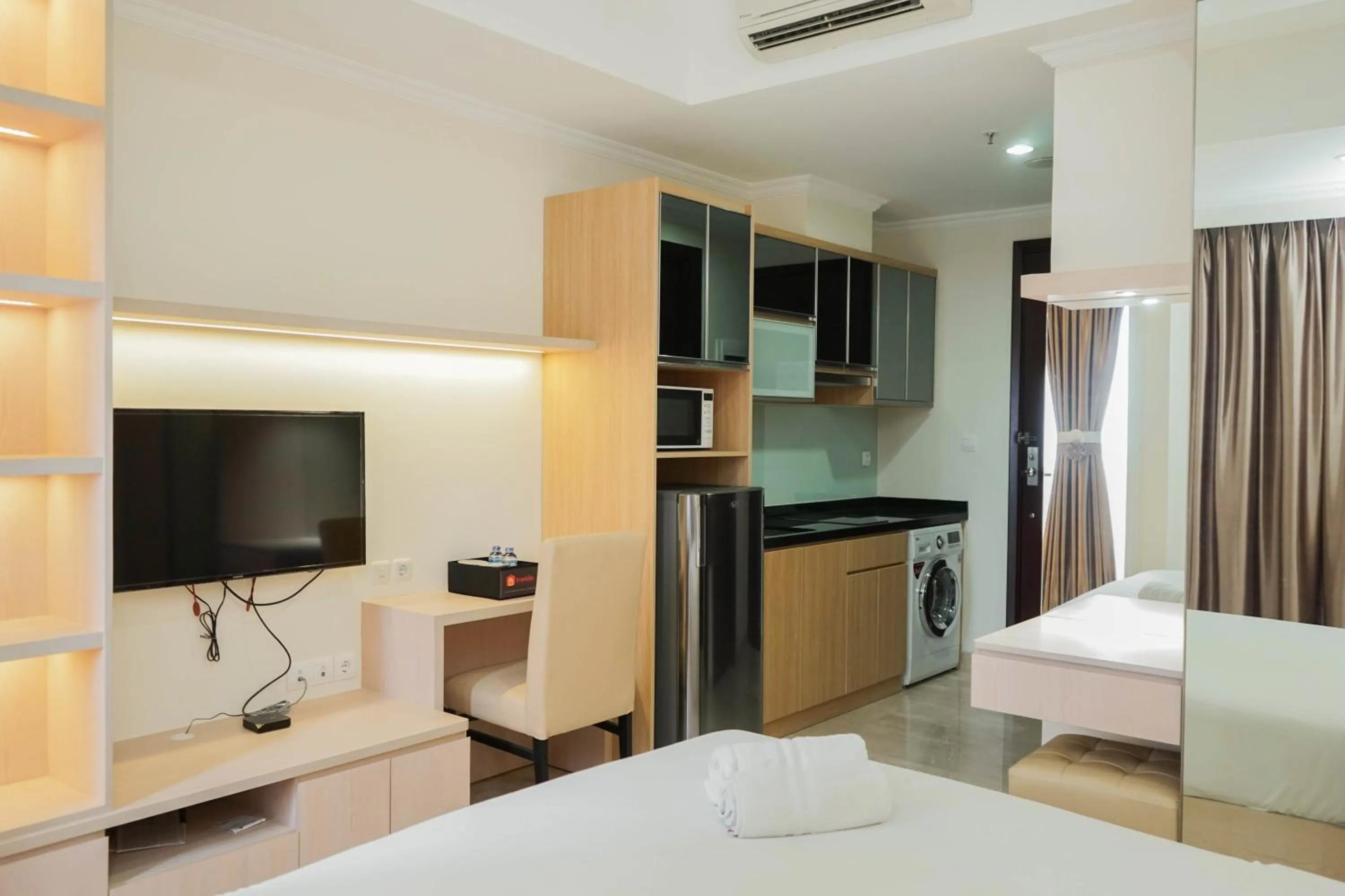 Bed in Comfy Studio Apartment at Menteng Park By Travelio