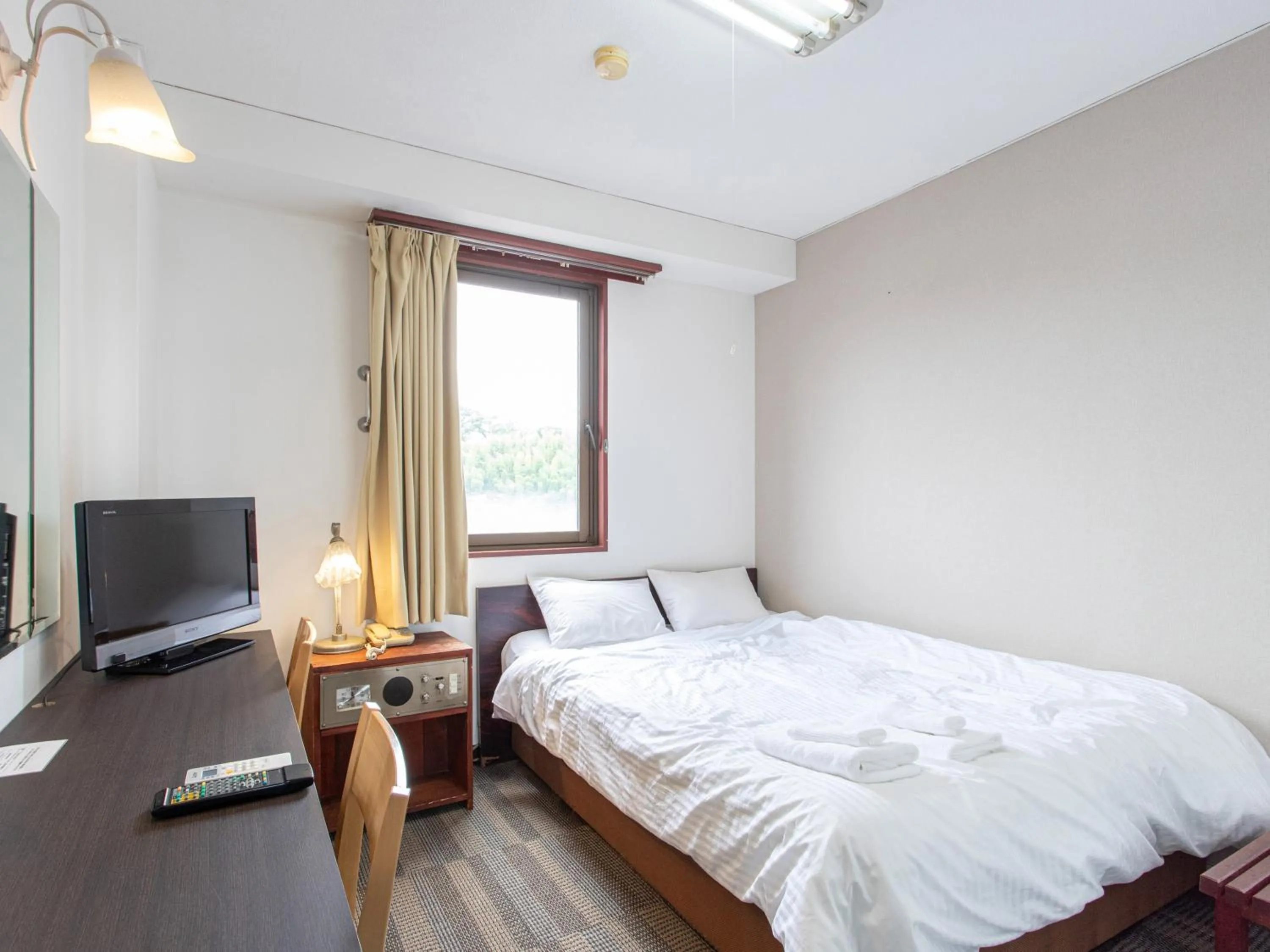 Photo of the whole room, Bed in Tabist New World Hotel Kagoshima Kanoya