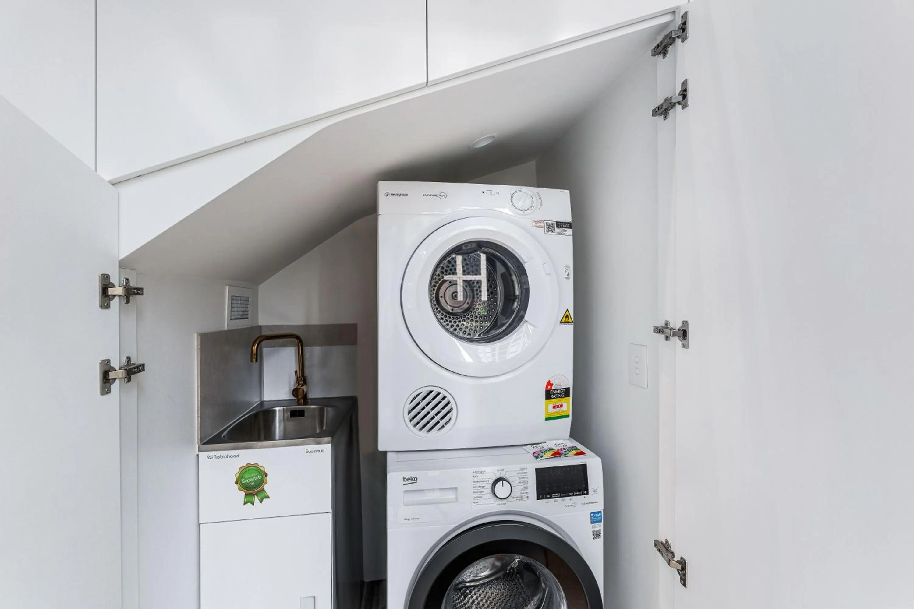 washing machine in Collins House Apartments by CLLIX