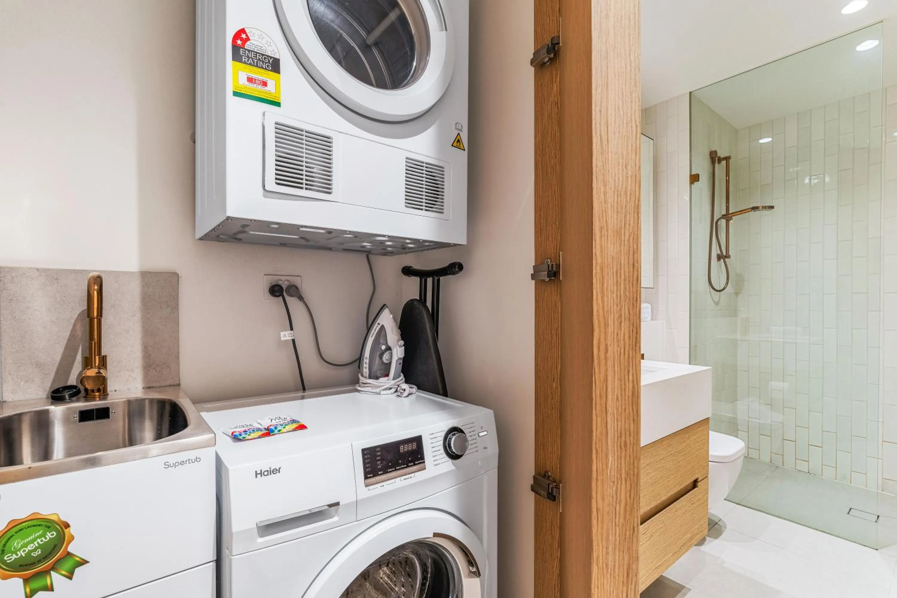 washing machine in Collins House Apartments by CLLIX