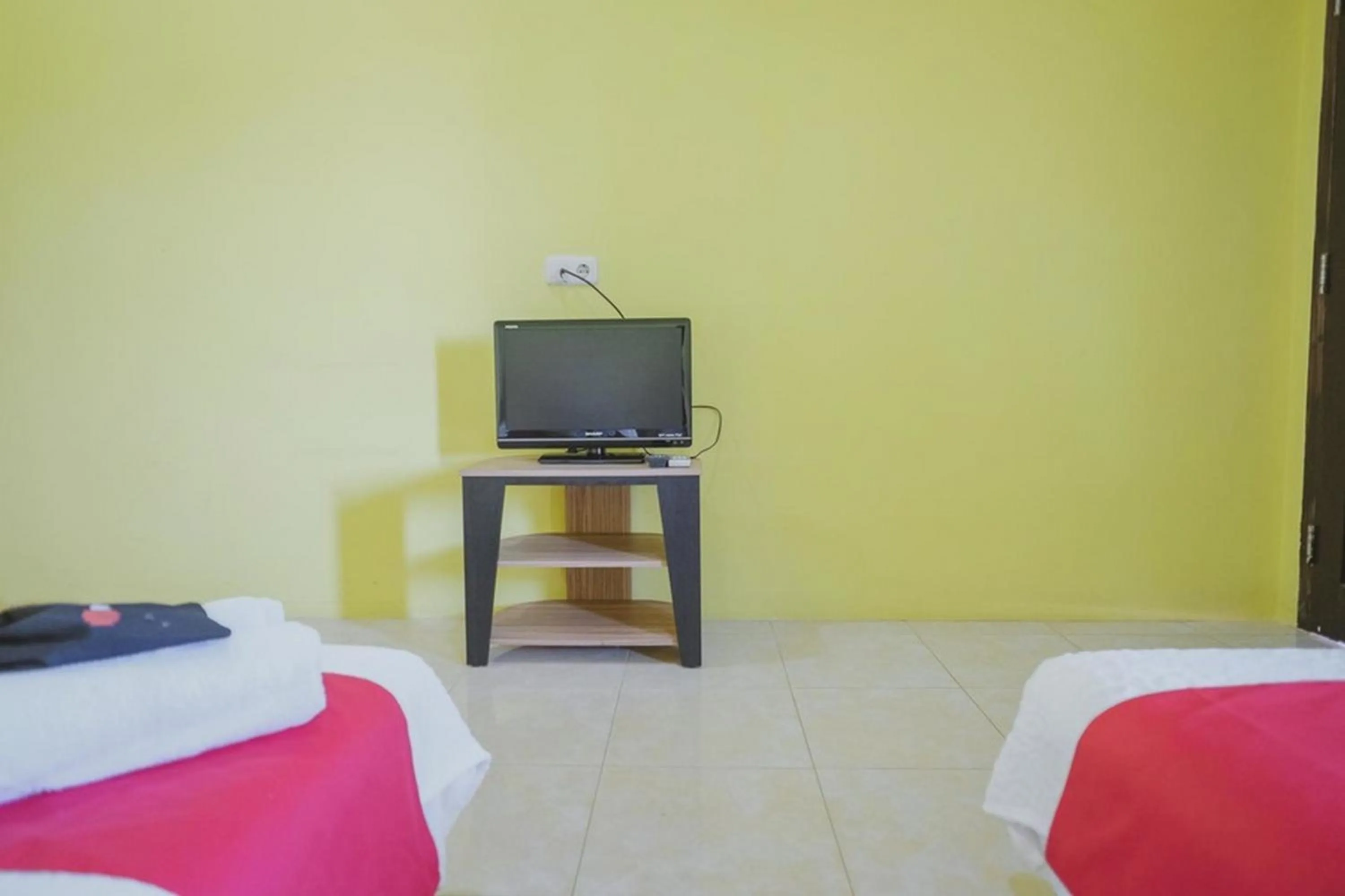 Communal lounge/ TV room, Bed in RedDoorz Syariah near Kantor Walikota Jambi