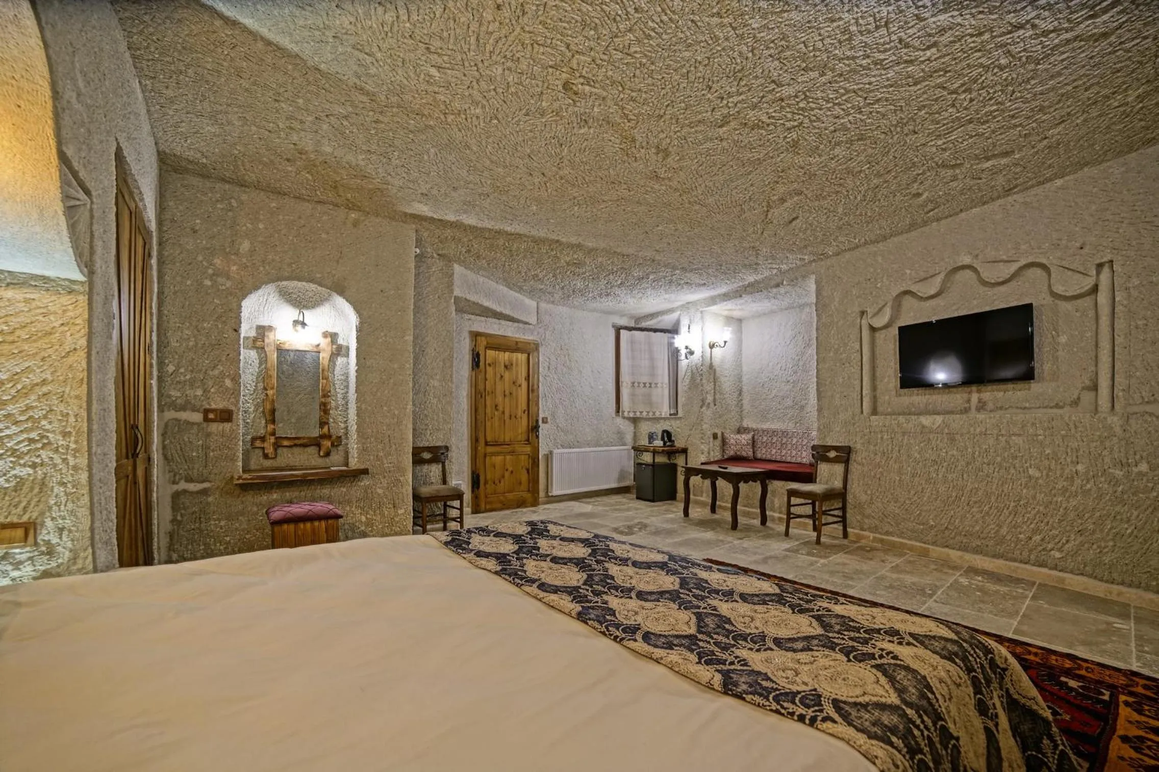 Bed in Risus Cave Suites