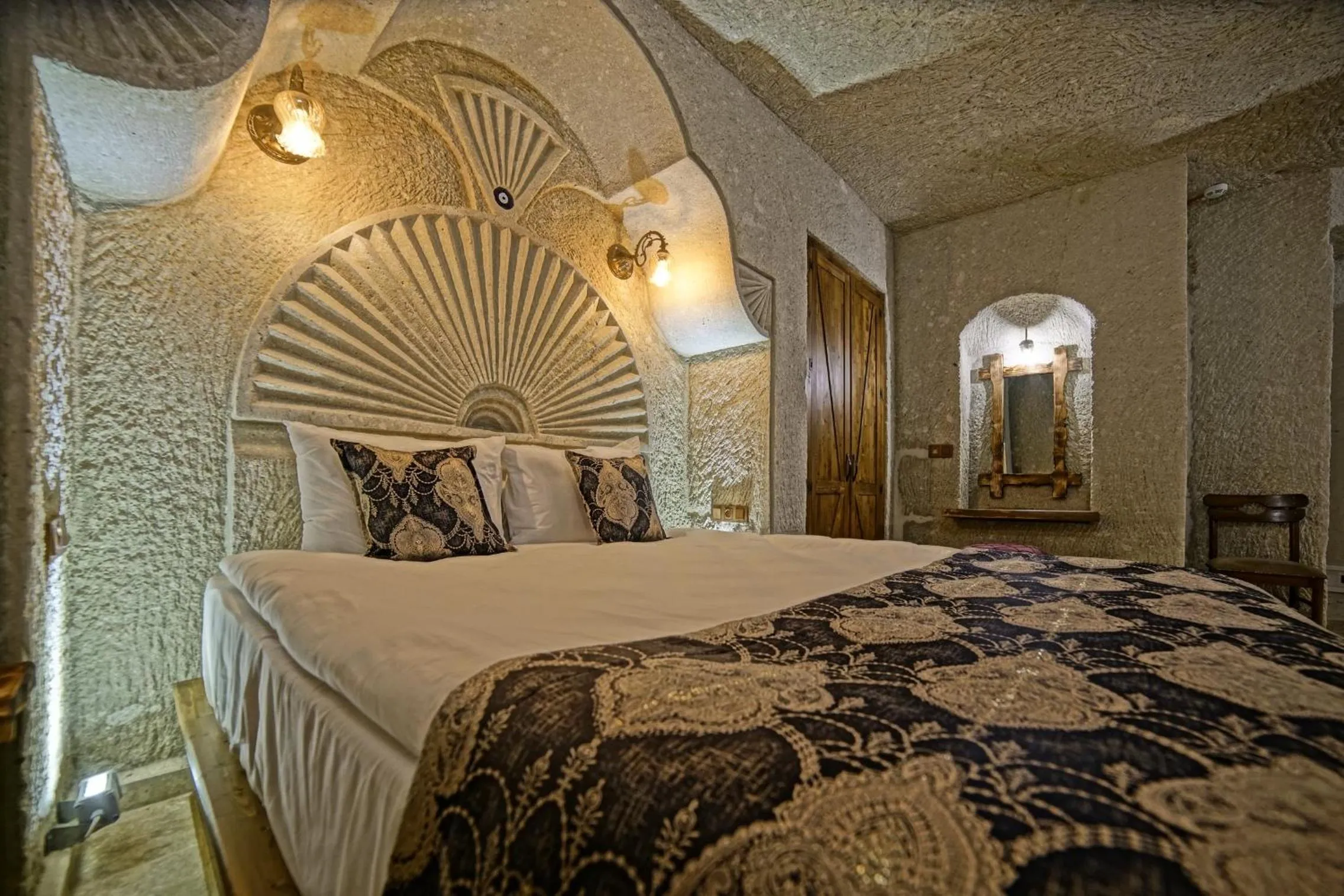 Bed in Risus Cave Suites