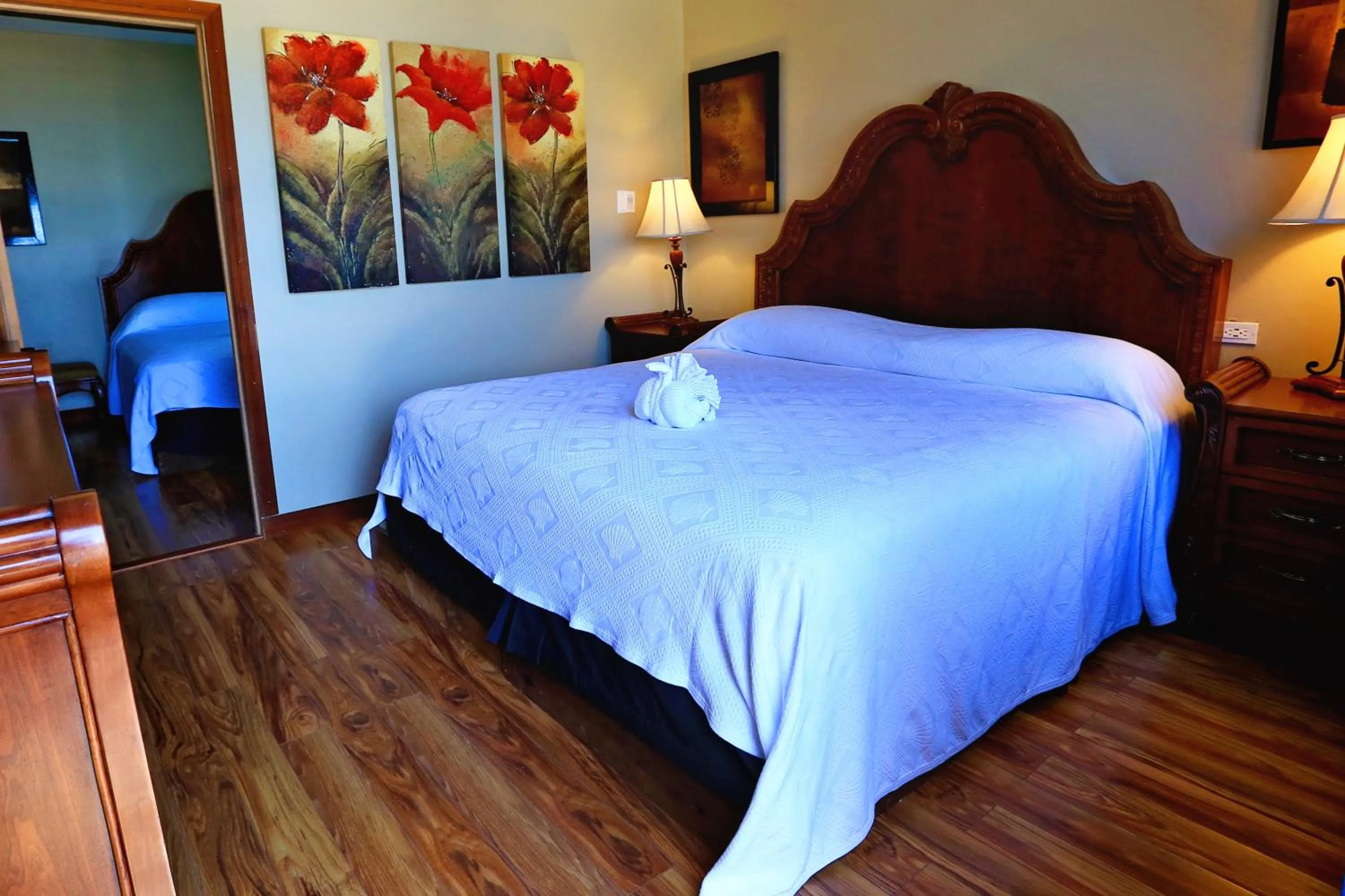 Bed in Hotel Royal Blue & Golf Cart Rental