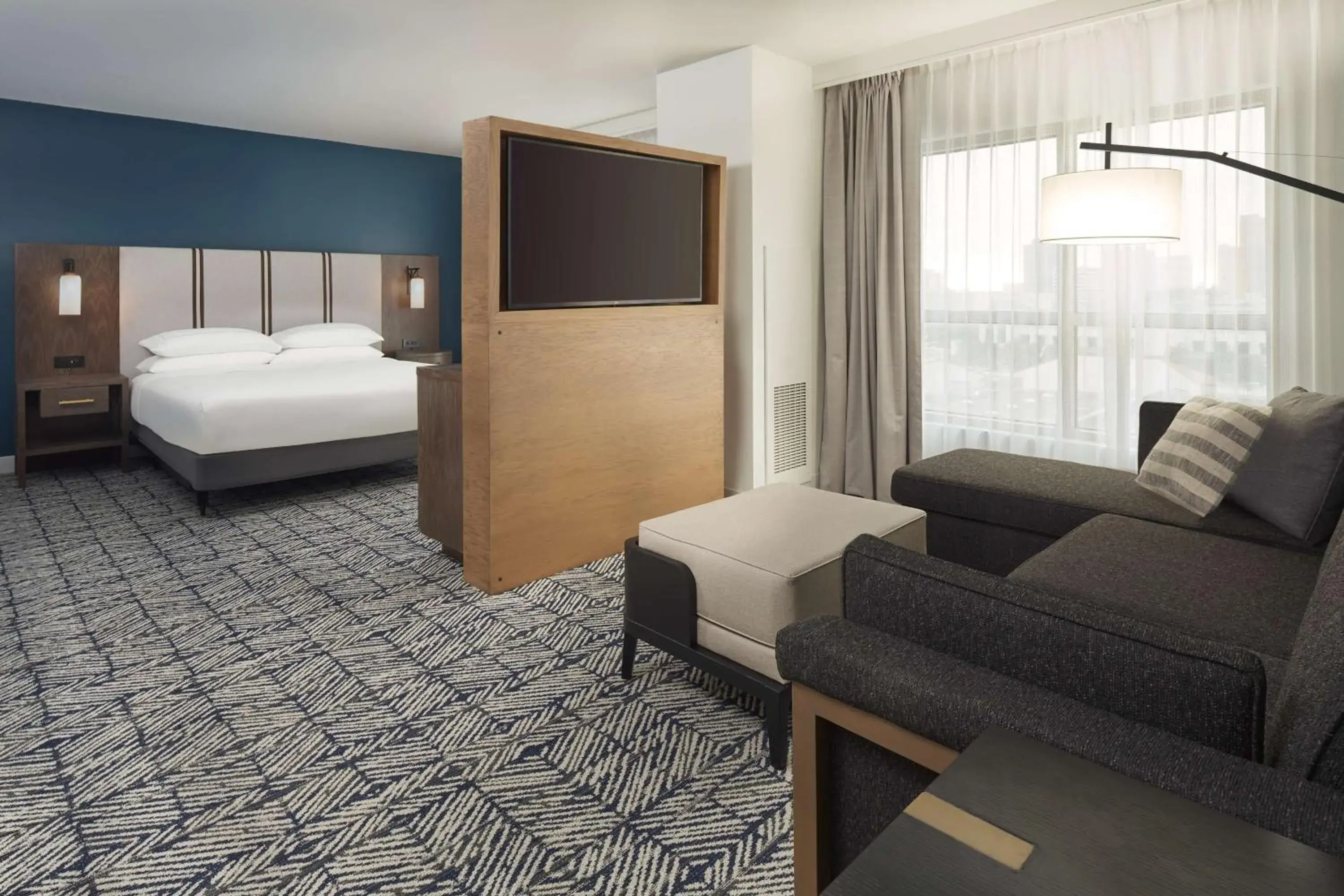 Living room, Bed in The Chifley Houston, Tapestry Collection by Hilton Living room, Bed in The Chifley Houston, Tapestry Collection by Hilton