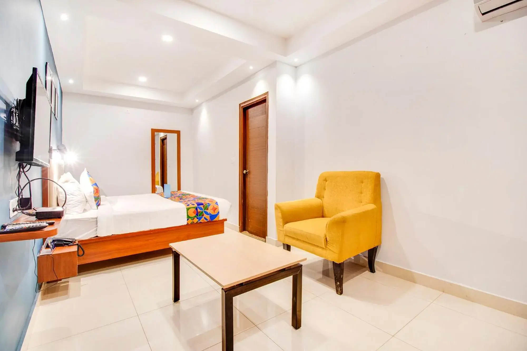 Seating area, Bed in FabHotel The Sun Suites - Yelahanka Seating area, Bed in FabHotel The Sun Suites - Yelahanka