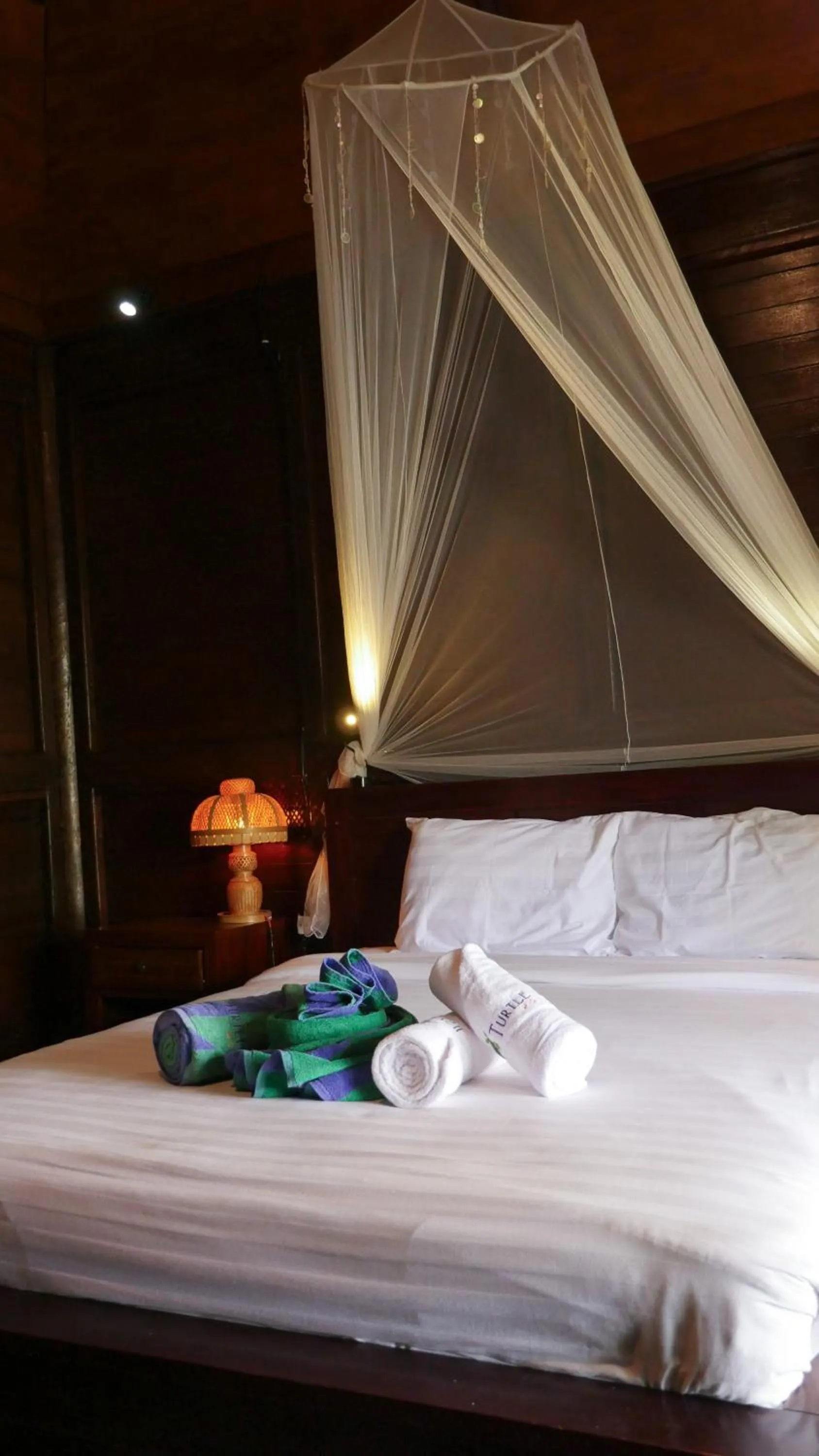 Bed in Turtle Garden Hotel