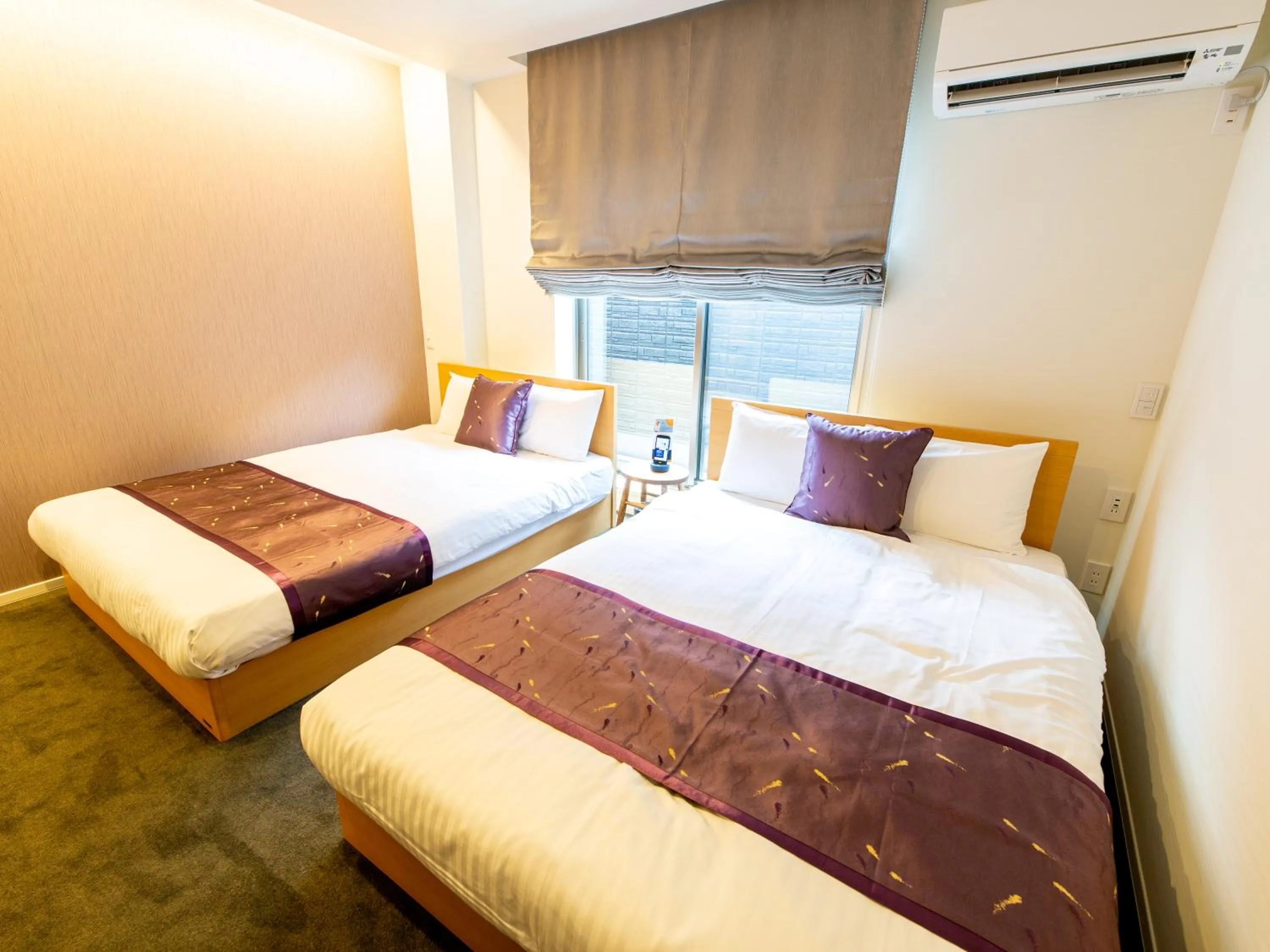 Bed in GRAND BASE Hiroshima Ekimae