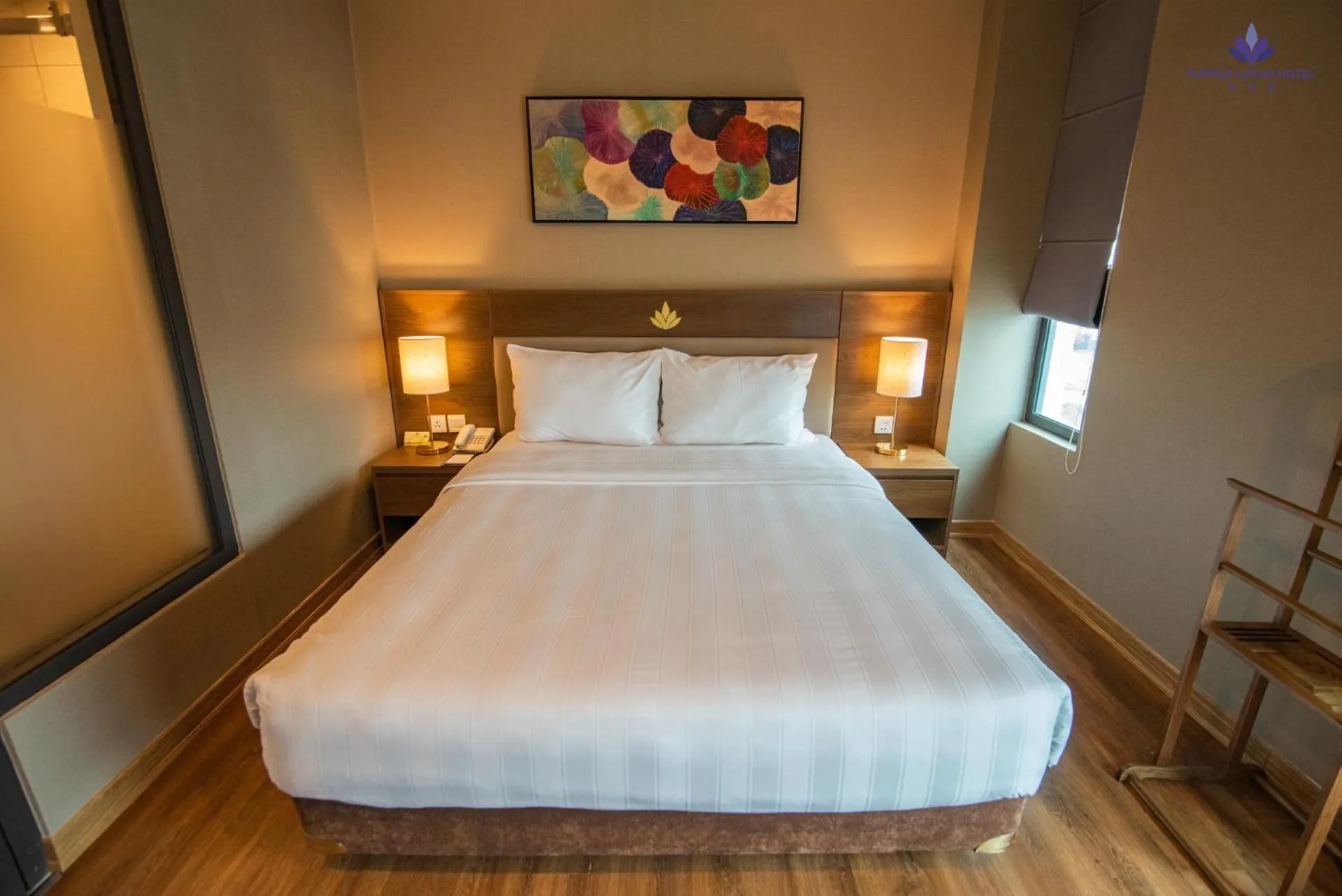 Bed in Purple Lotus Hotel