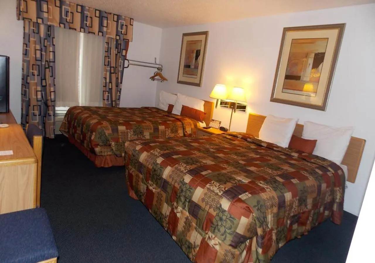 Bed in Norwood Inn and Suites - Minneapolis-St Paul Roseville