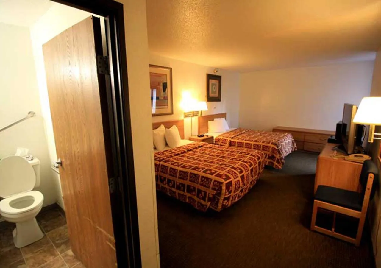 Bed in Norwood Inn and Suites - Minneapolis-St Paul Roseville