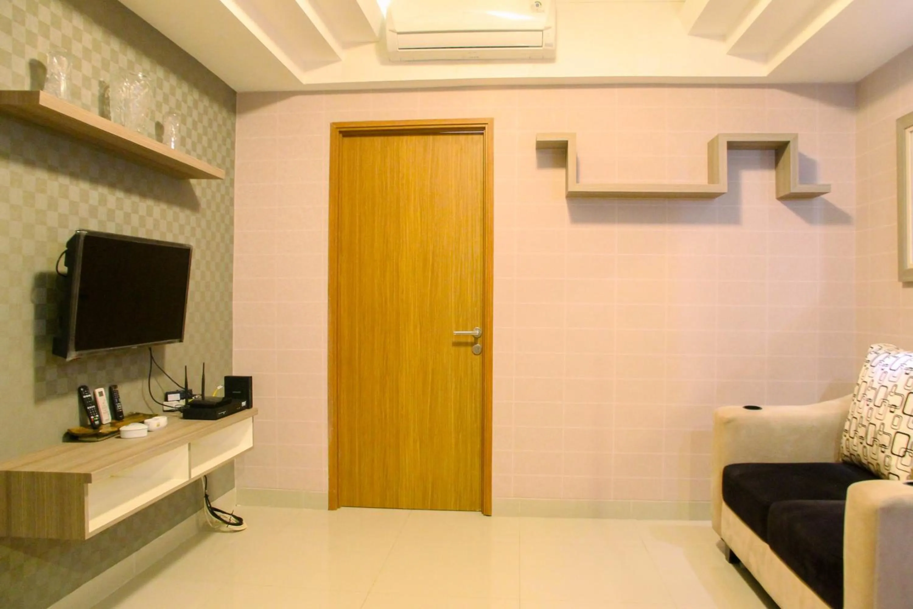 Living room in Best Price 1BR Apartment at The Oasis Cikarang By Travelio