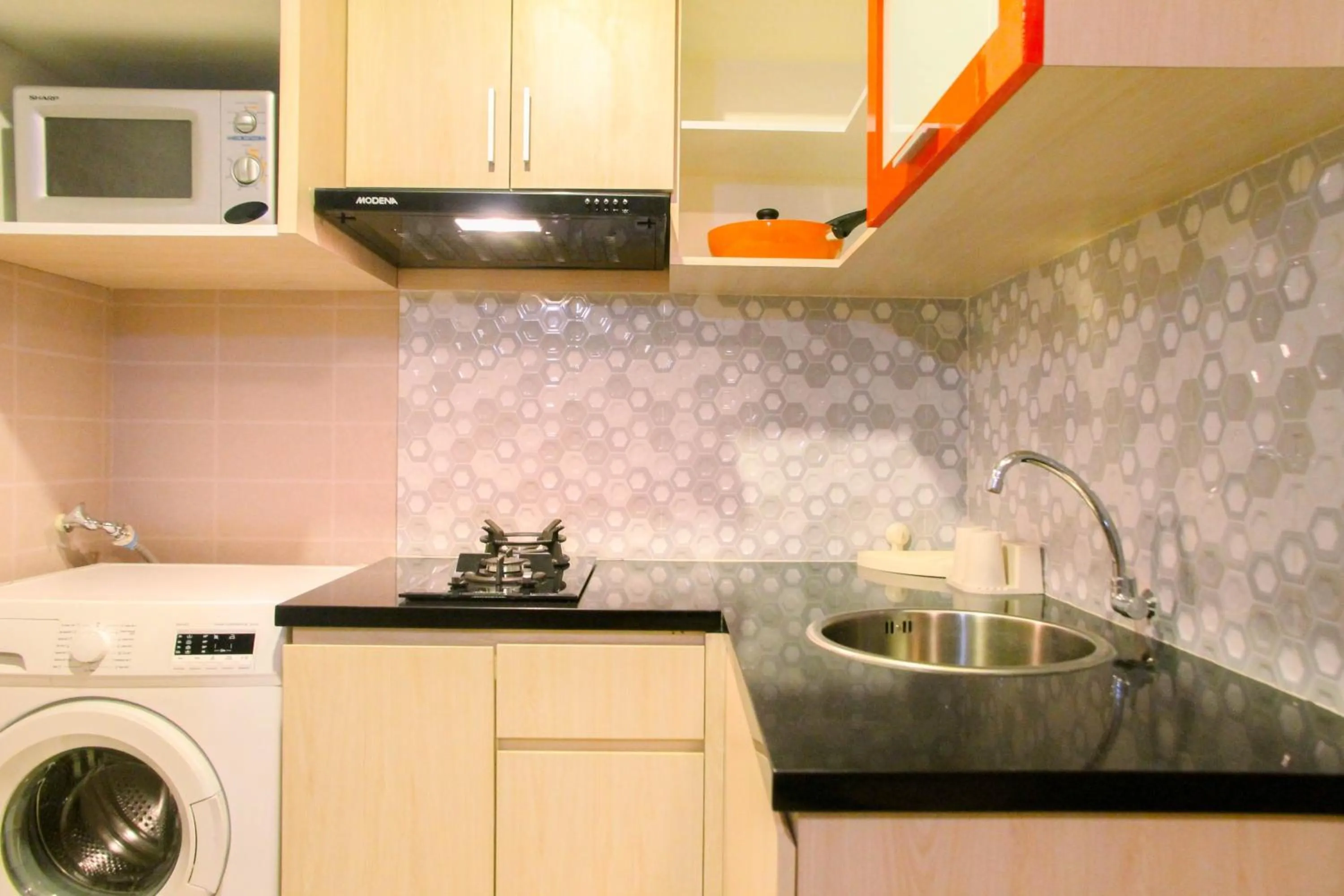 Kitchen or kitchenette in Best Price 1BR Apartment at The Oasis Cikarang By Travelio