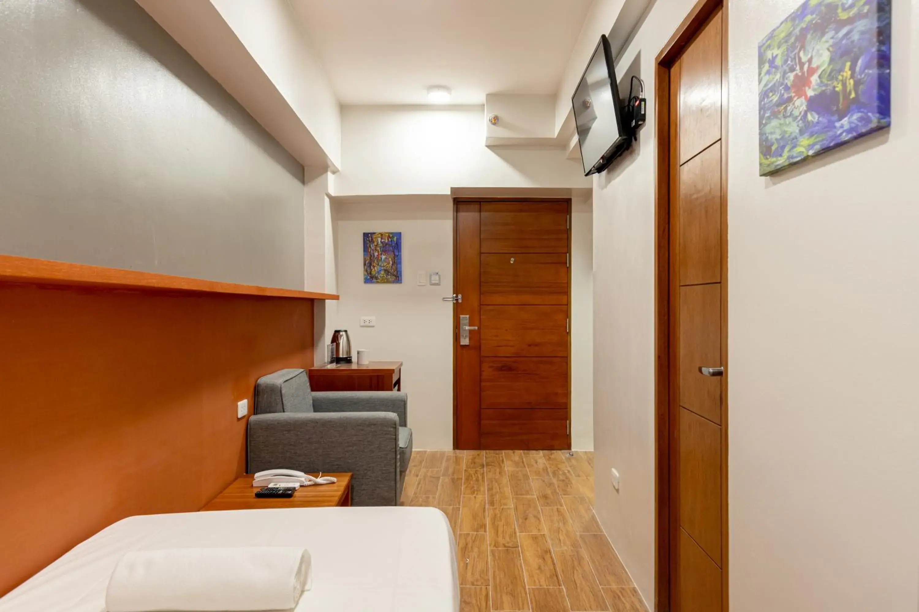 Seating area, Bed in iHotel Uptown BGC Seating area, Bed in iHotel Uptown BGC