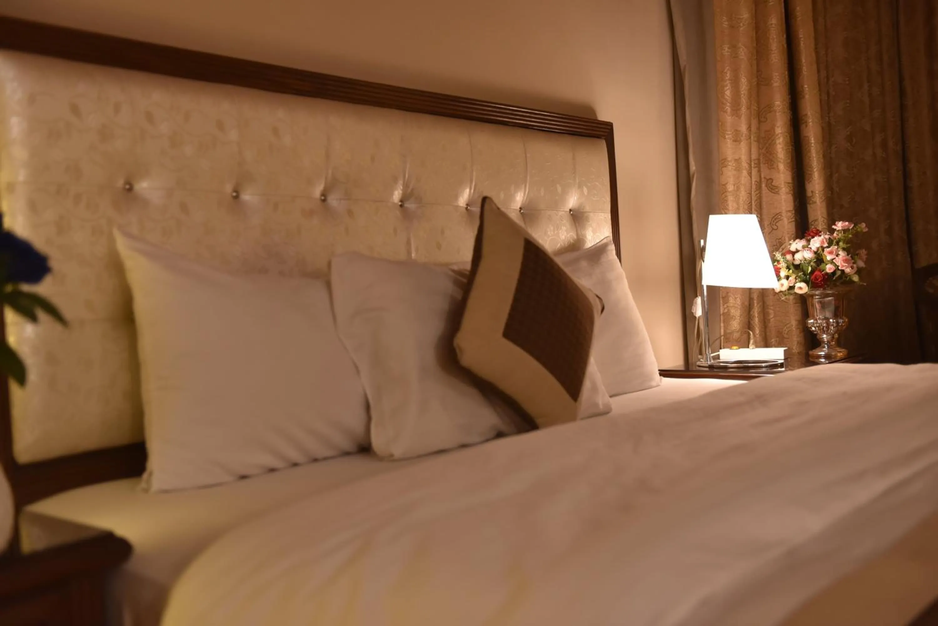 Bed in Shalimar Tower Hotel Lahore