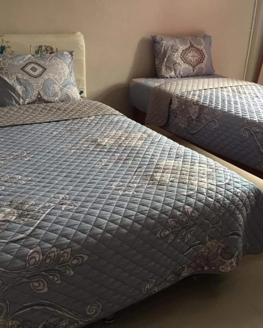 Bed in SMILE HOME GUESTHOUSE