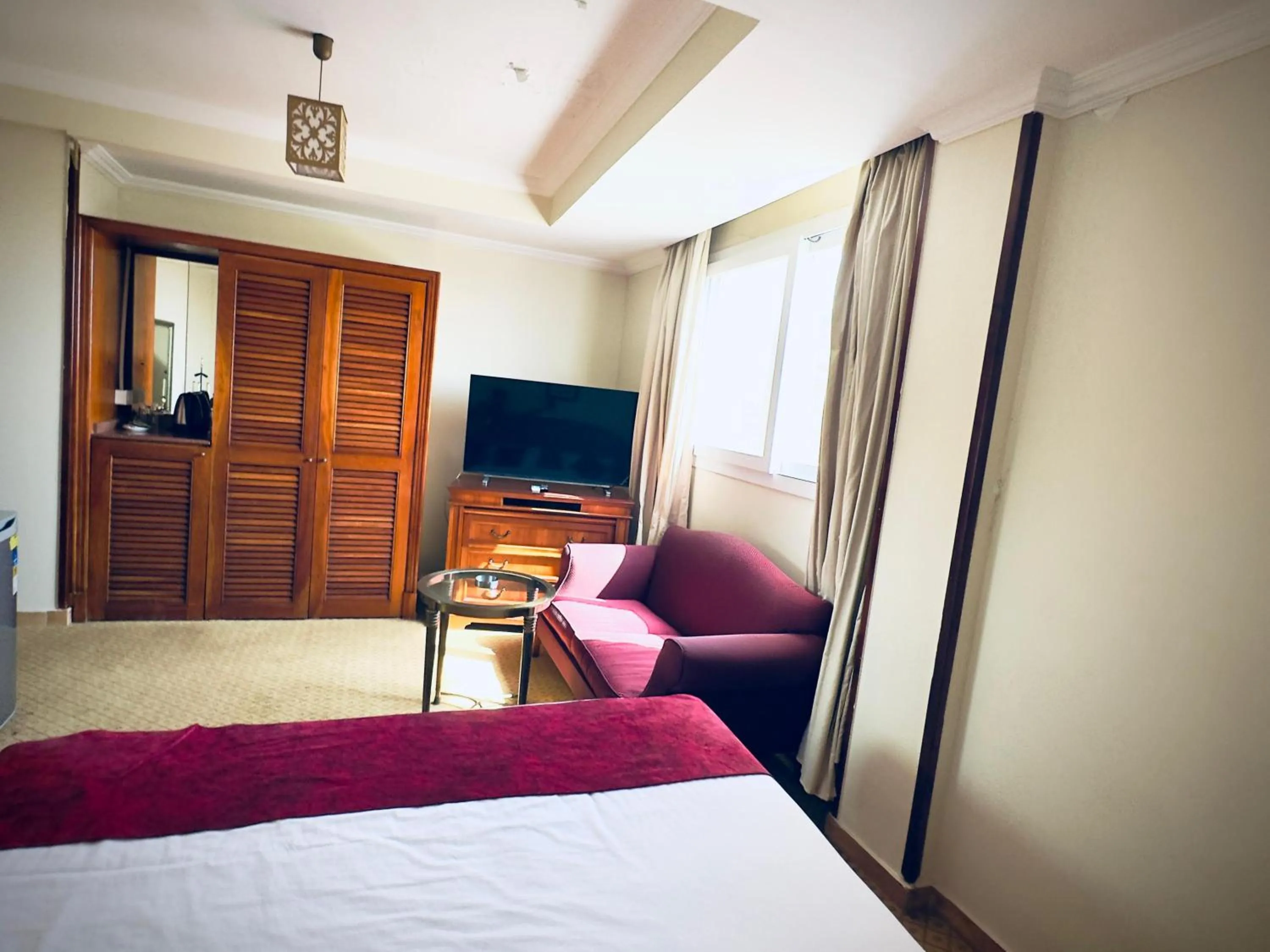 Communal lounge/ TV room, Bed in PYRAMIDS TOWER Inn