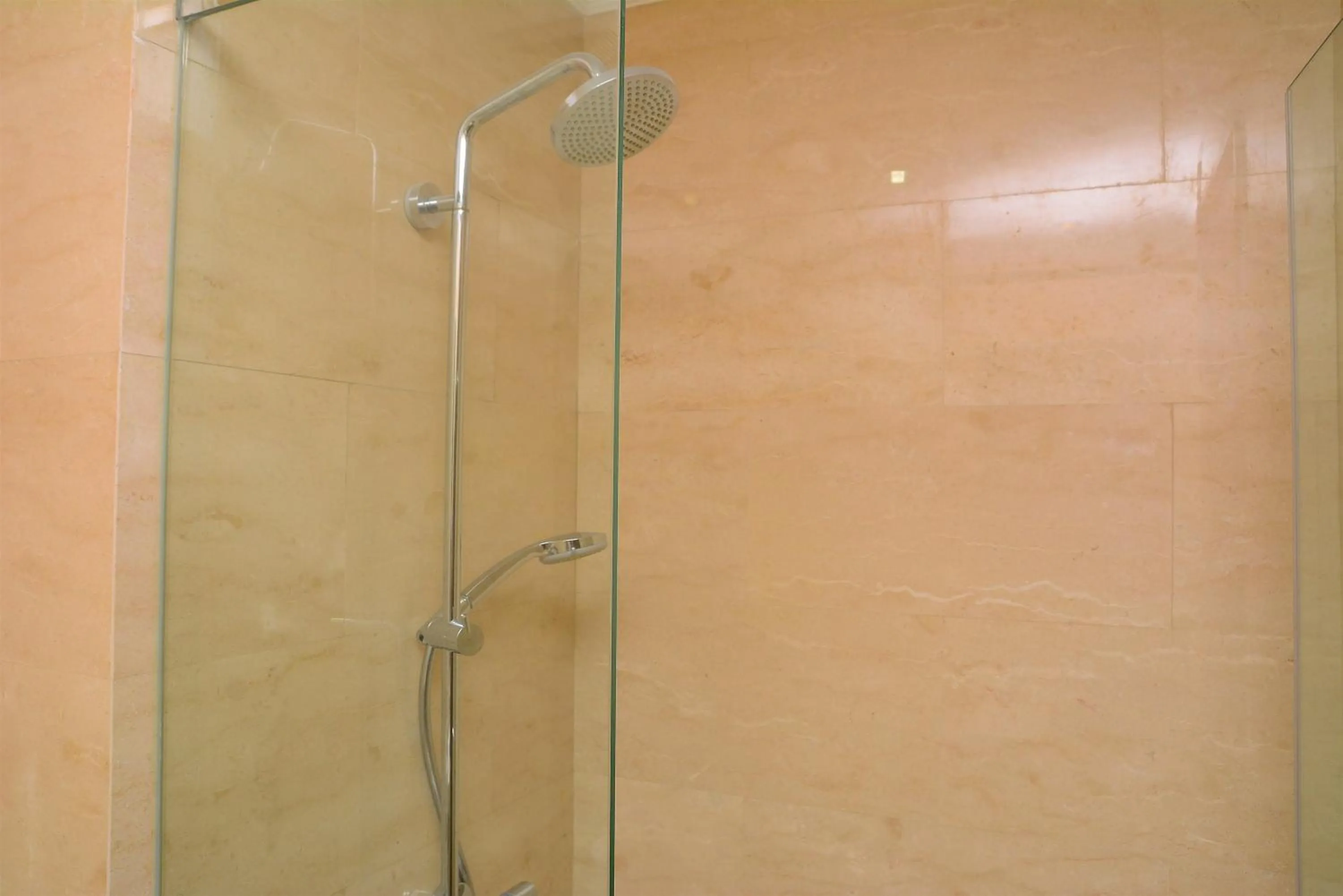 Bathroom in Tranquil Studio Apartment at Menteng Park By Travelio