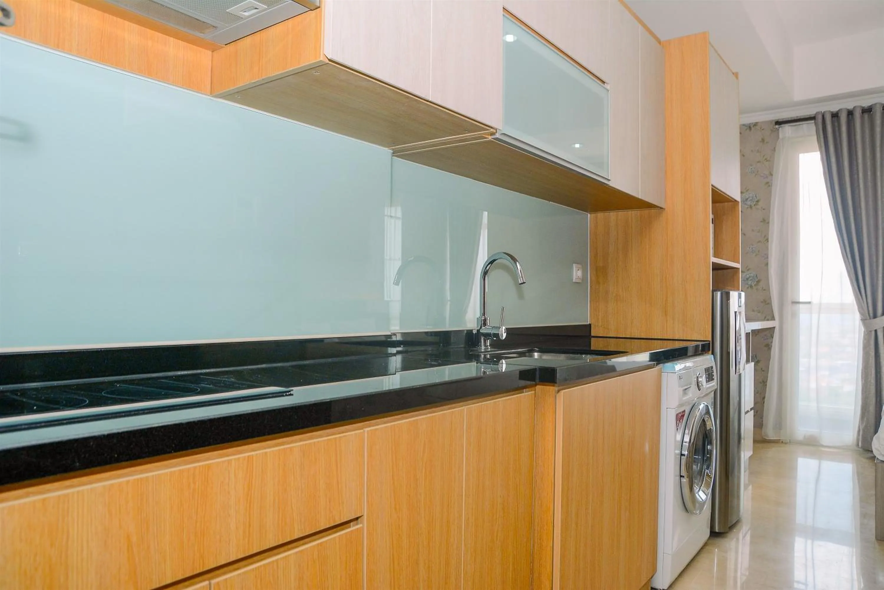Kitchen or kitchenette in Tranquil Studio Apartment at Menteng Park By Travelio