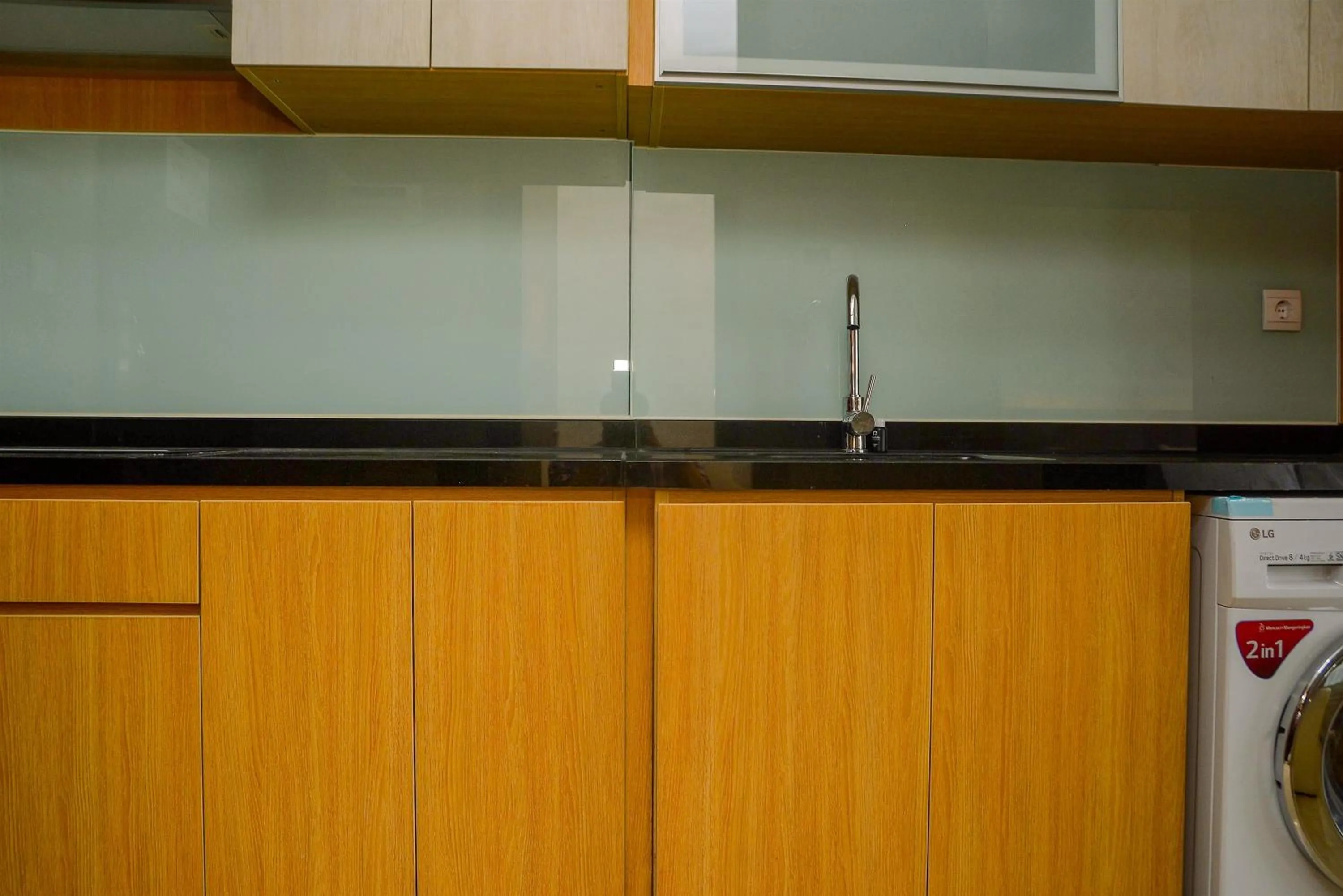 Kitchen or kitchenette in Tranquil Studio Apartment at Menteng Park By Travelio