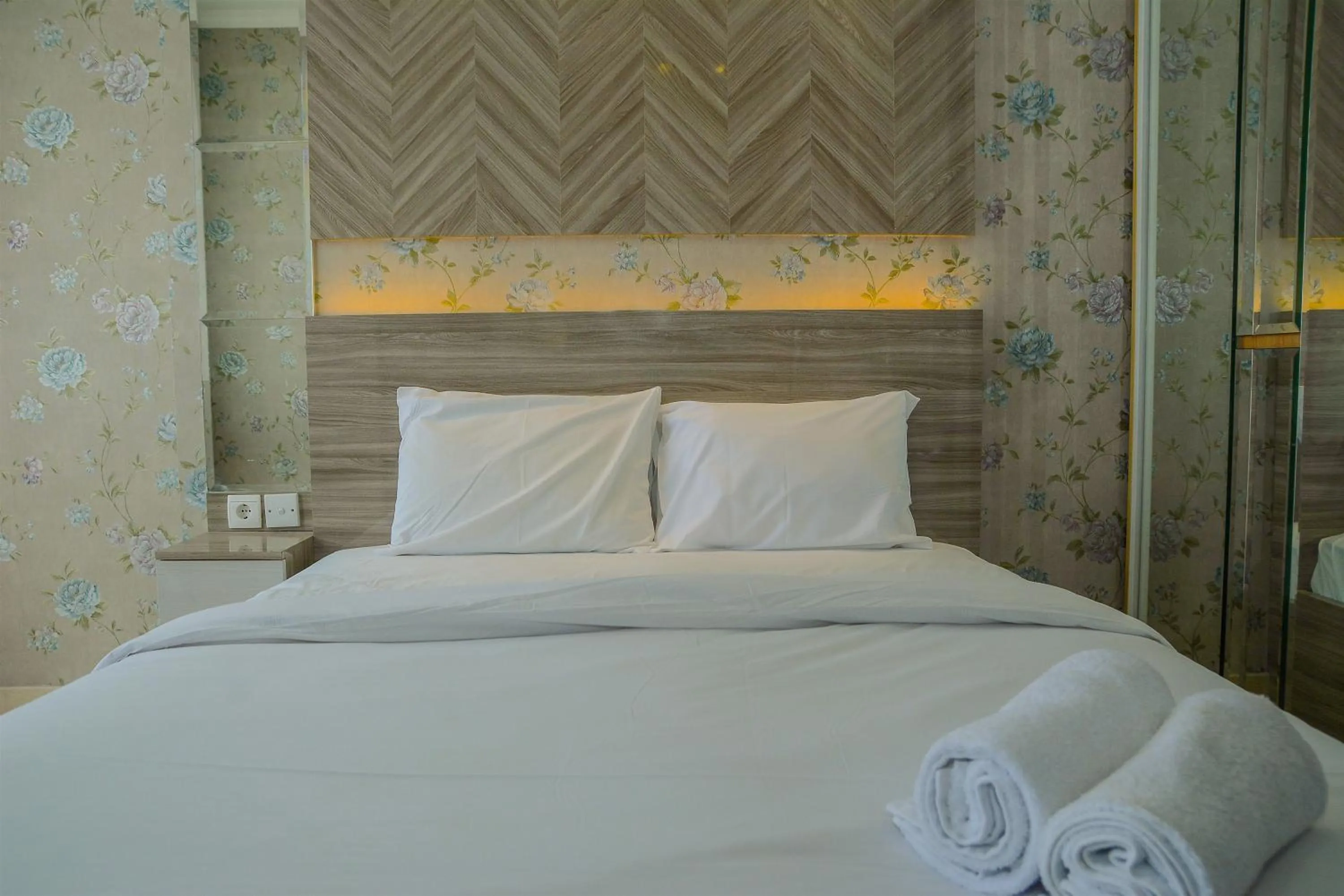 Bed in Tranquil Studio Apartment at Menteng Park By Travelio