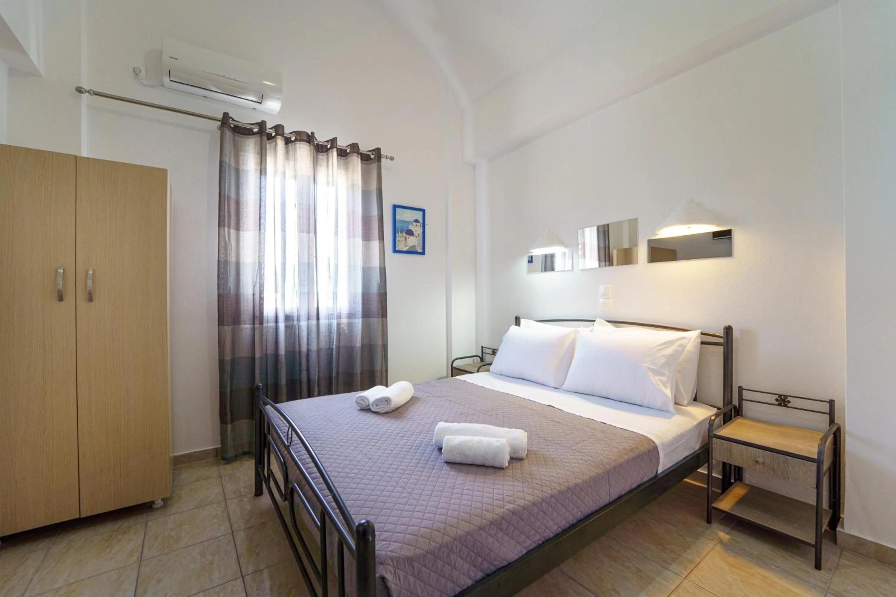 Bed in Marousi Rooms
