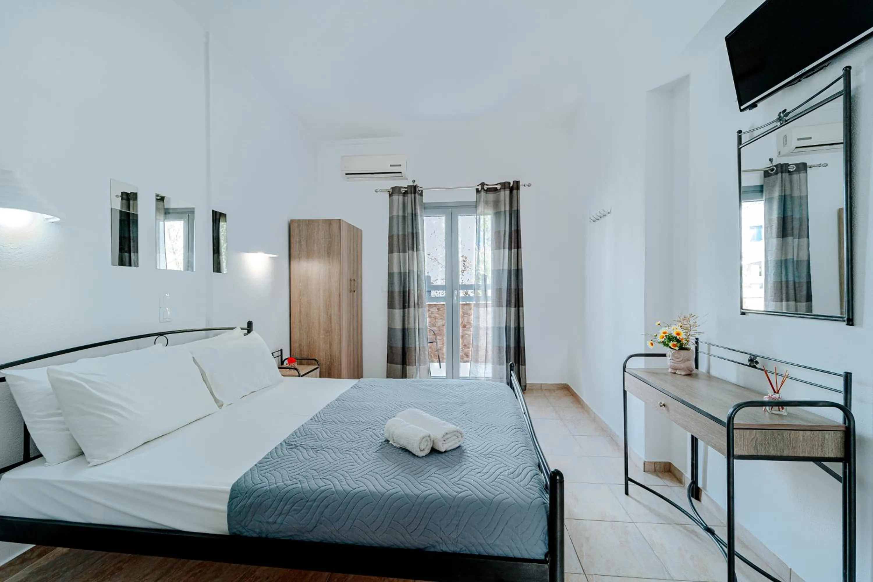 Bed in Marousi Rooms