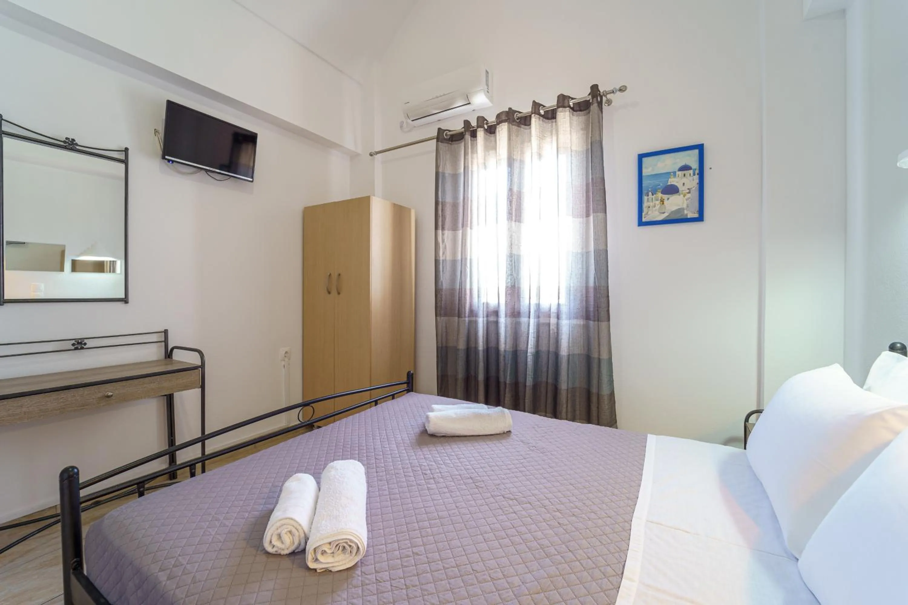Bed in Marousi Rooms