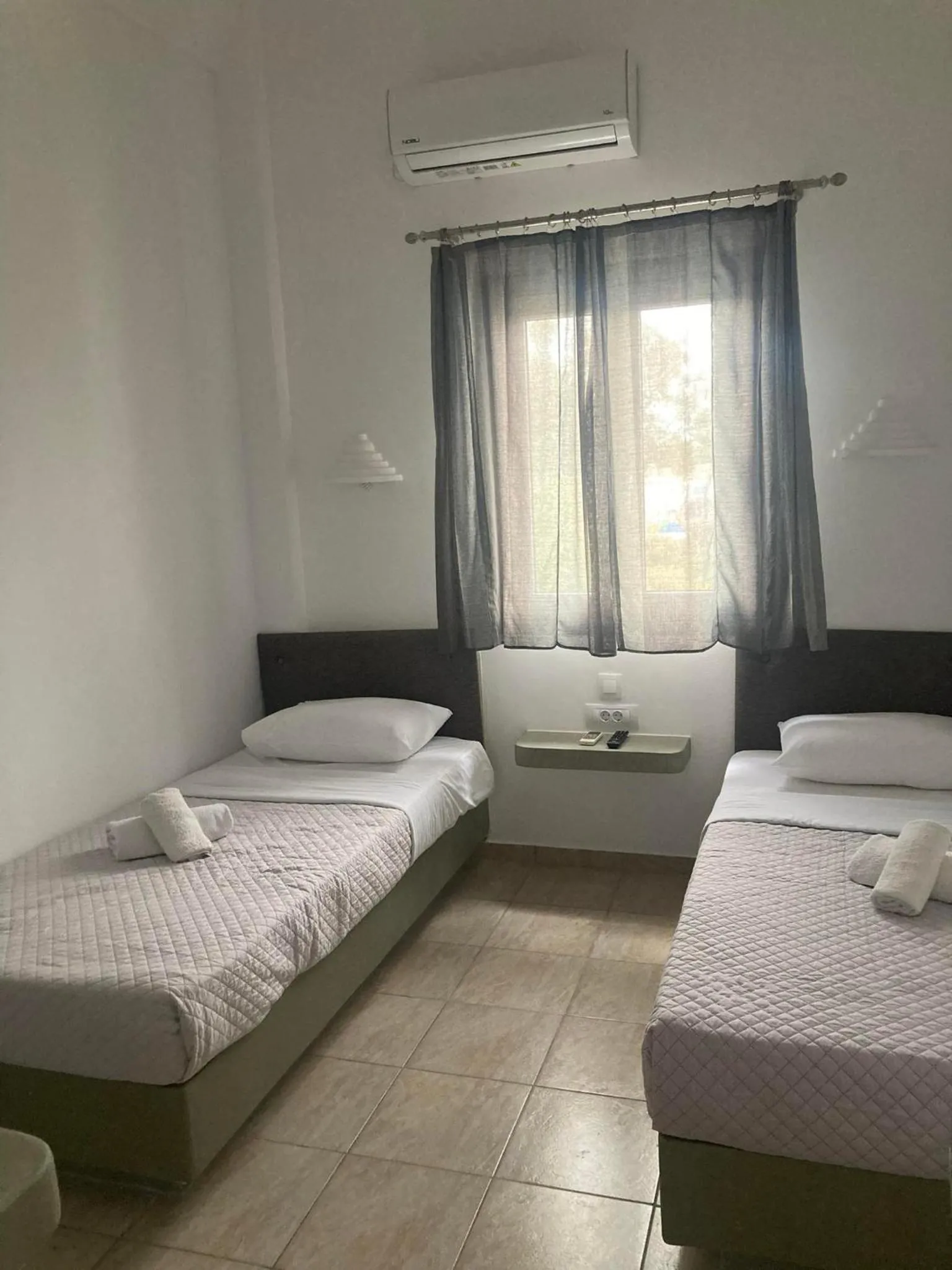 Bed in Marousi Rooms