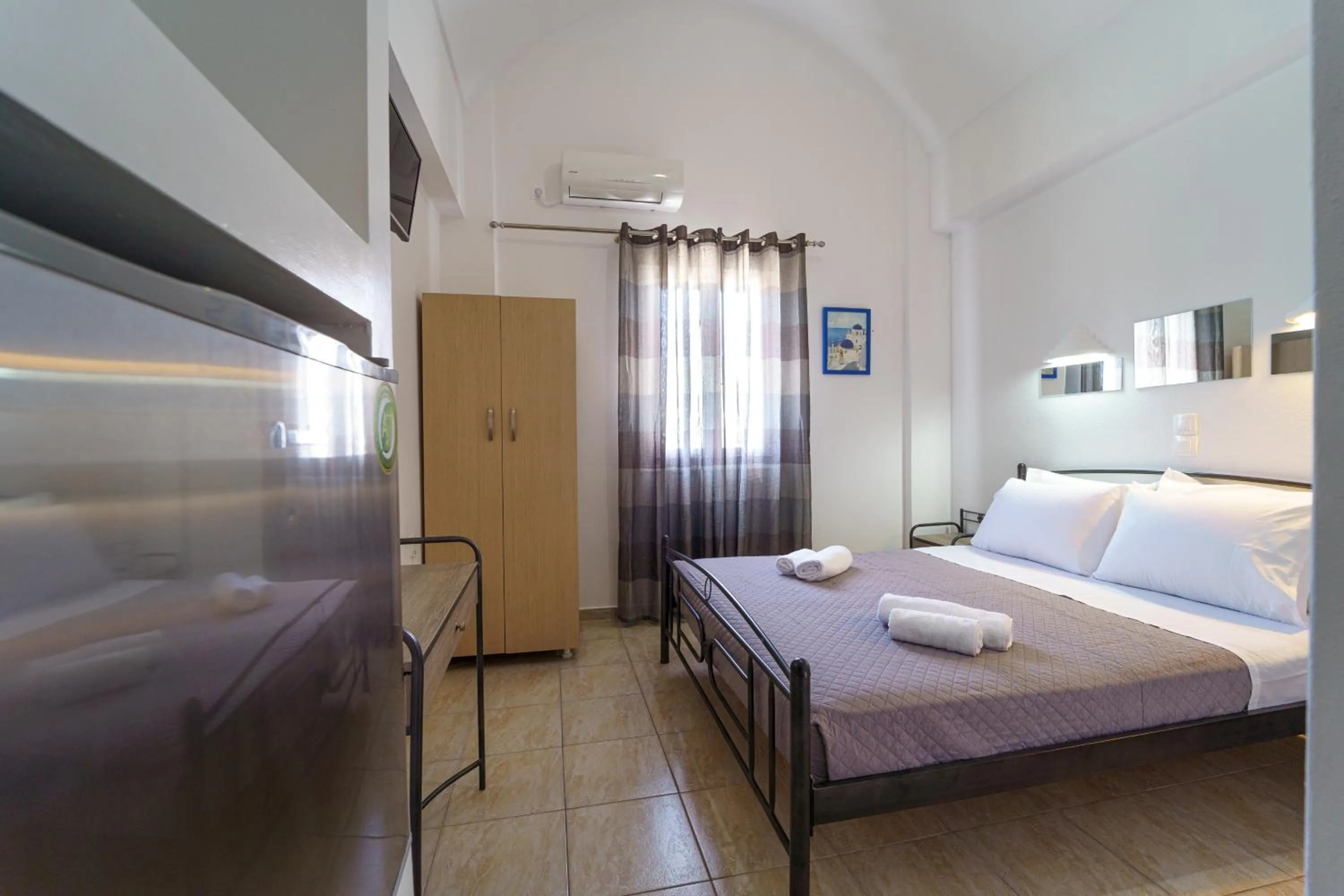 Bed in Marousi Rooms