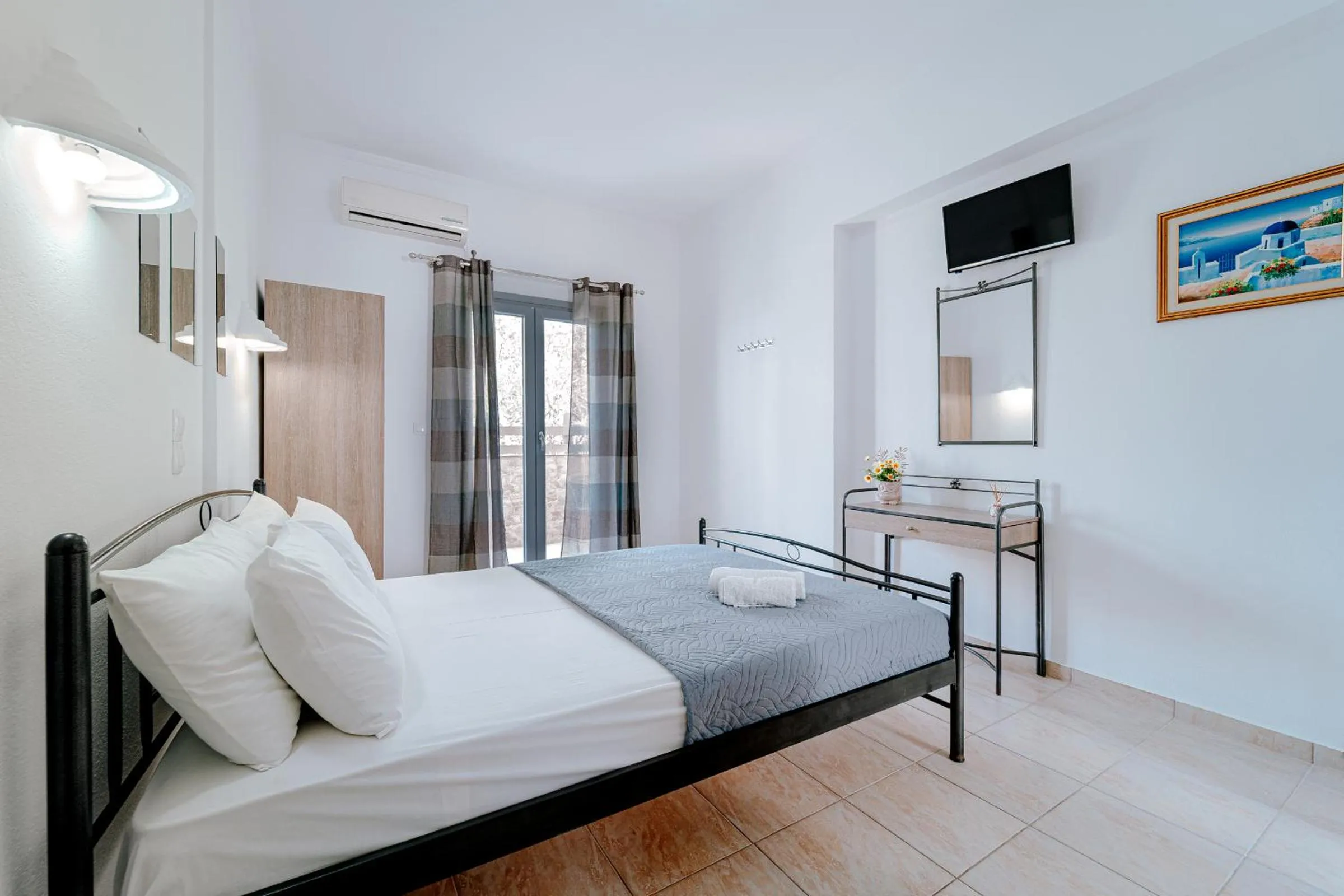 Bed in Marousi Rooms